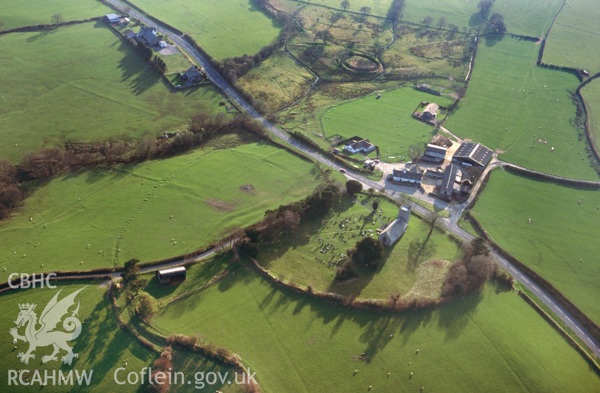 Slide of RCAHMW colour oblique aerial view of Llanafan Fawr Church and Moat., taken by C.R. Musson, 13/4/1995.