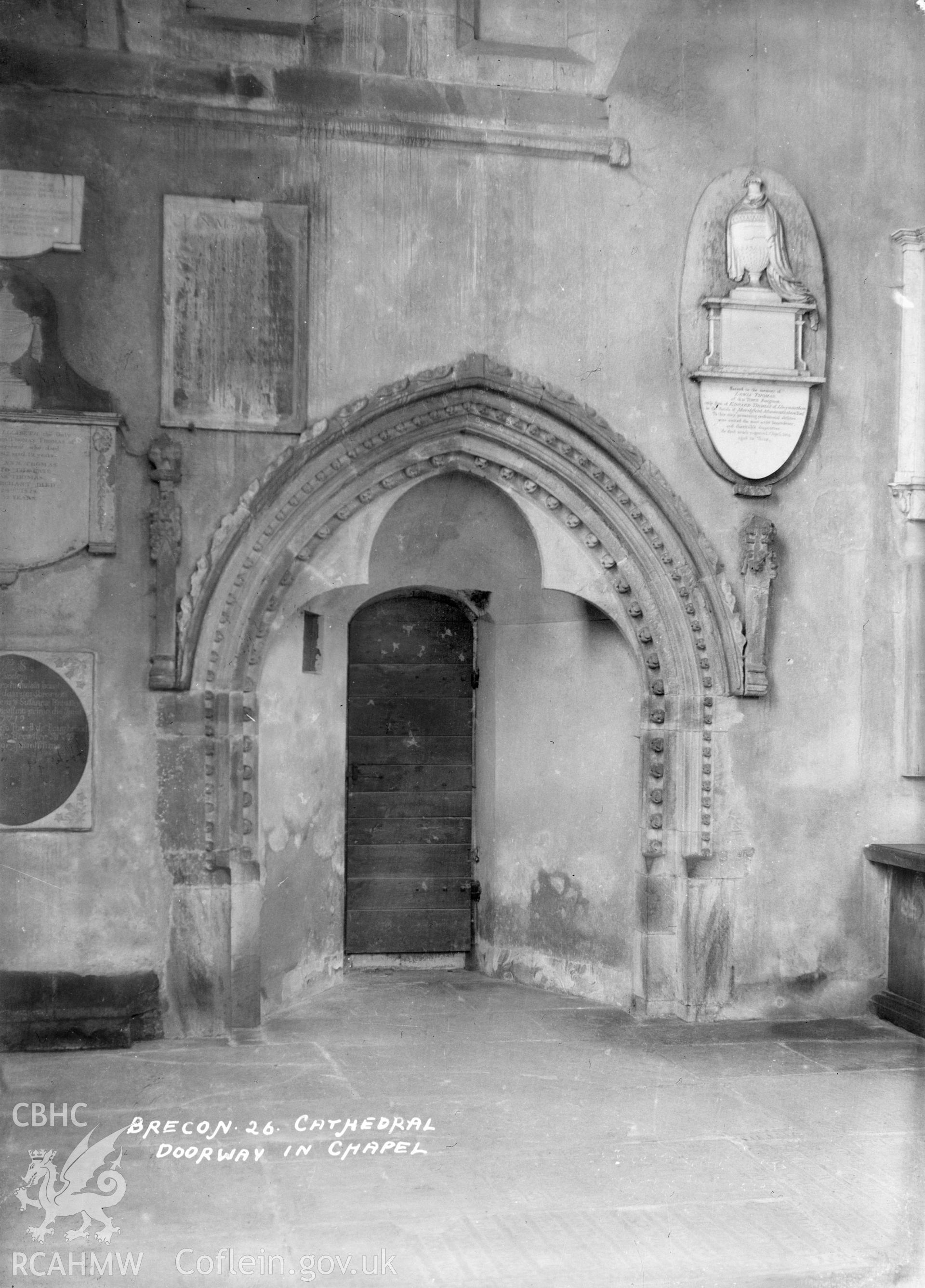 Interior view of Brecon Cathedral showing a doorway in the Chapel,  taken by W A Call circa 1920.