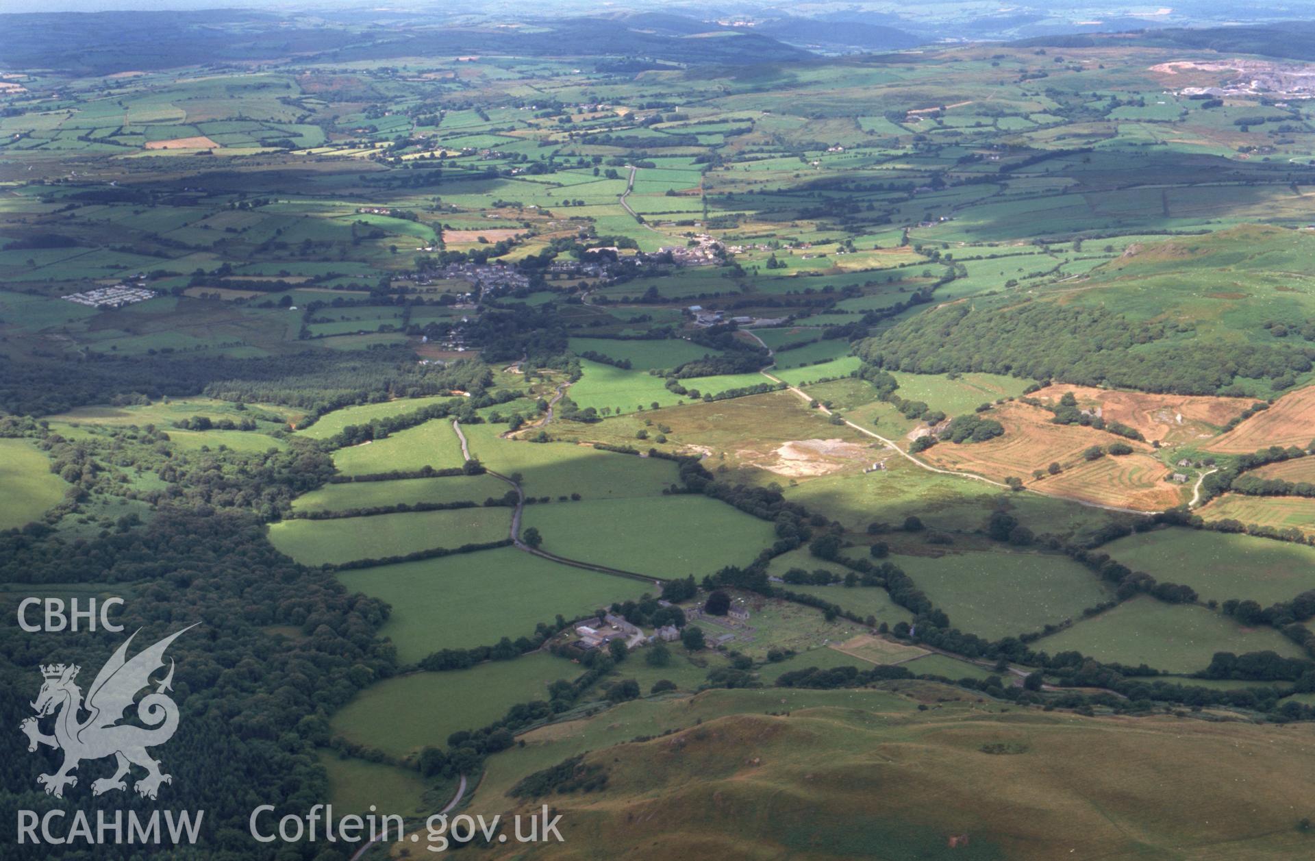 RCAHMW colour oblique aerial photograph of Strata Florida Abbey, long landscape view from east. Taken by Toby Driver on 05/08/2002