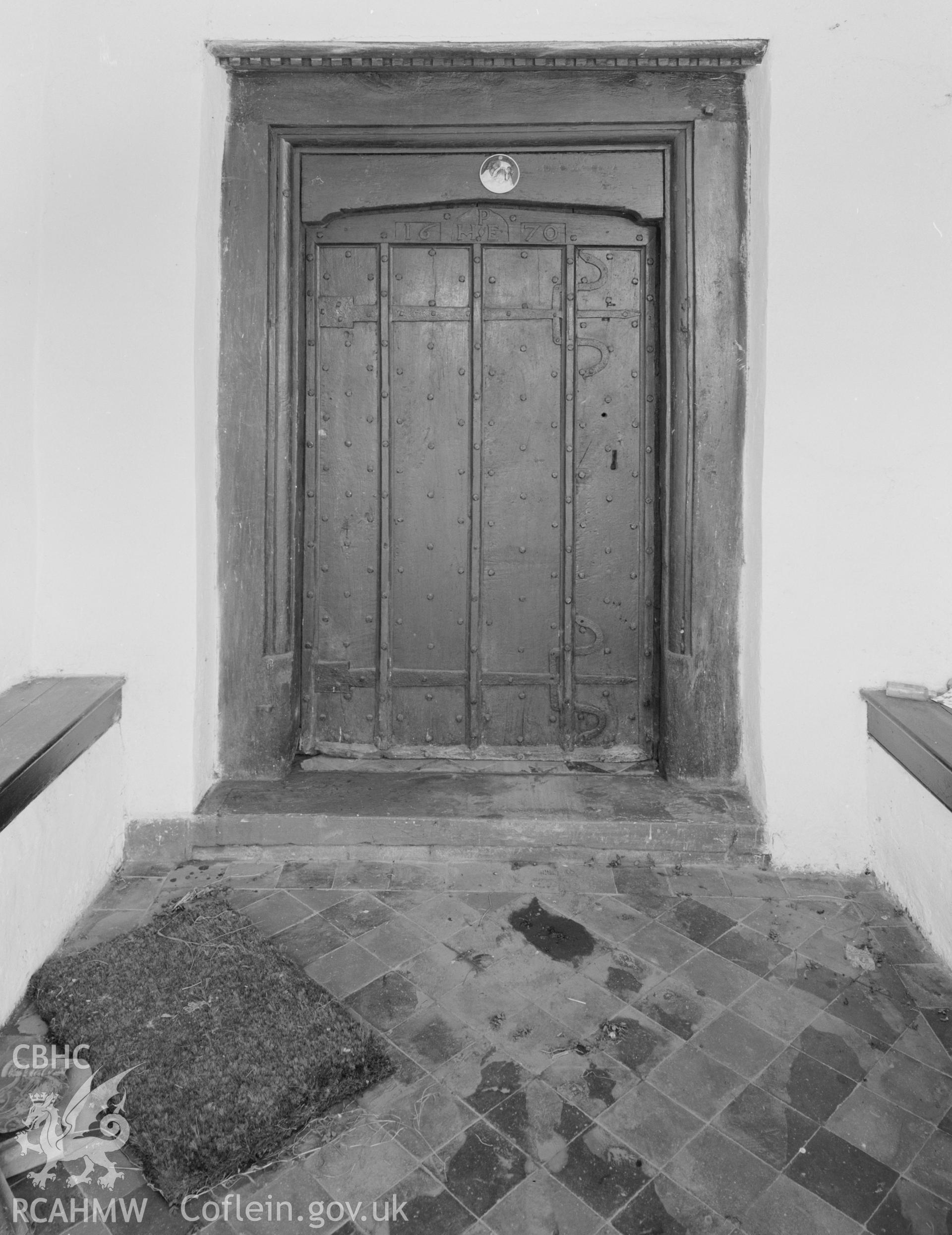 Interior view of farmhouse, showing oak door