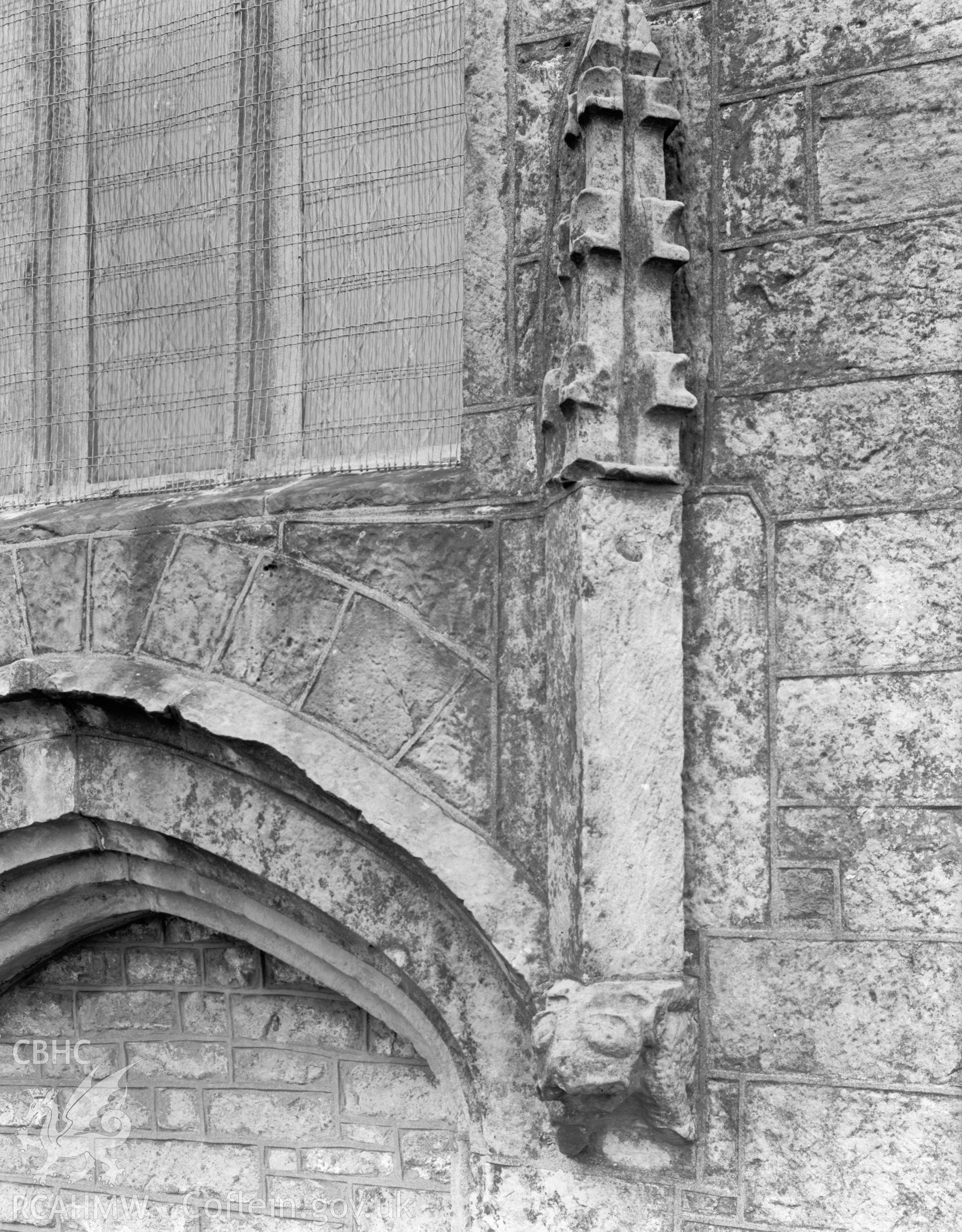 Exterior view showing detail of stonework above blocked doorway.