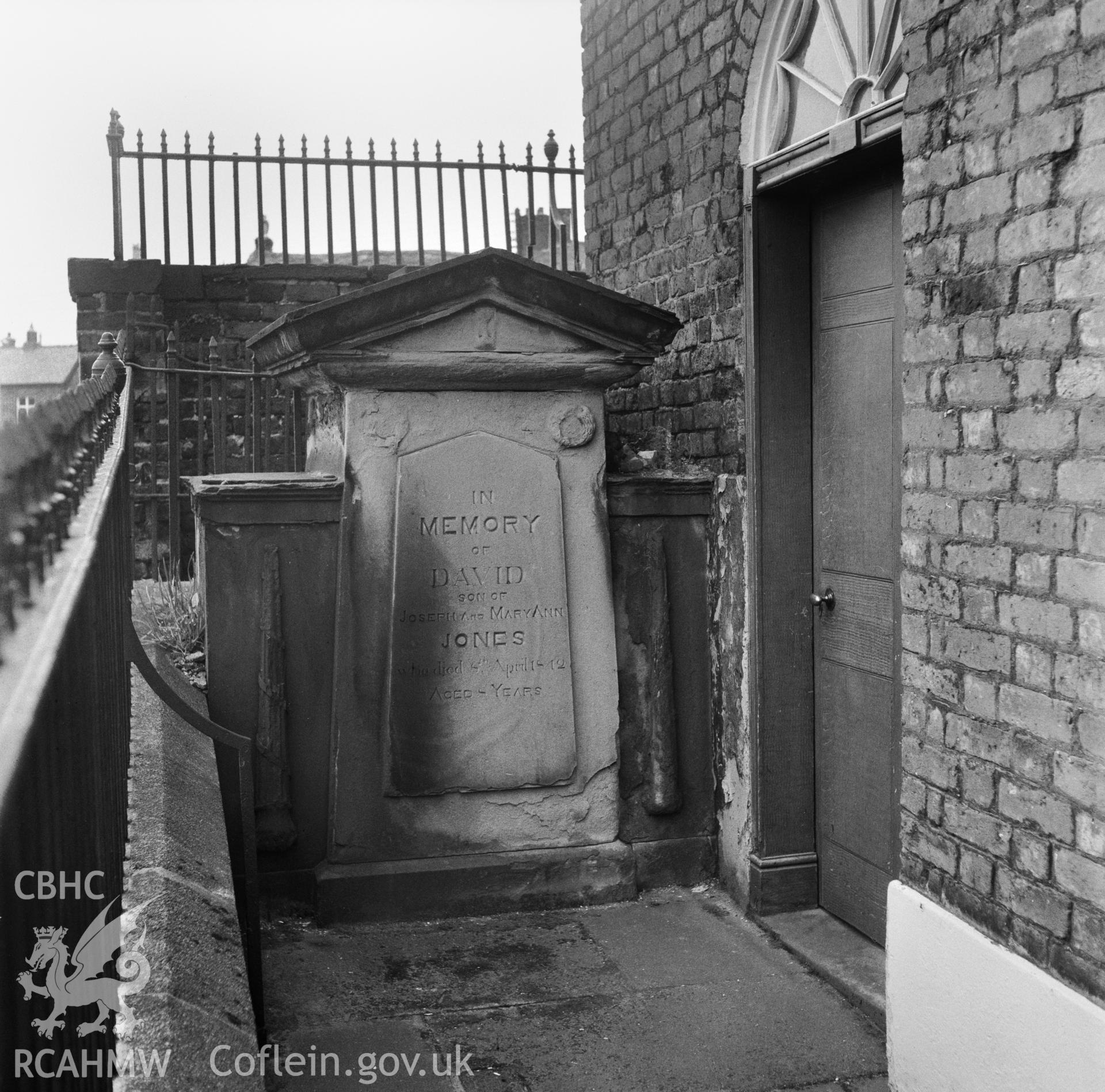 Exterior view showing monument by the east door of the north facade.