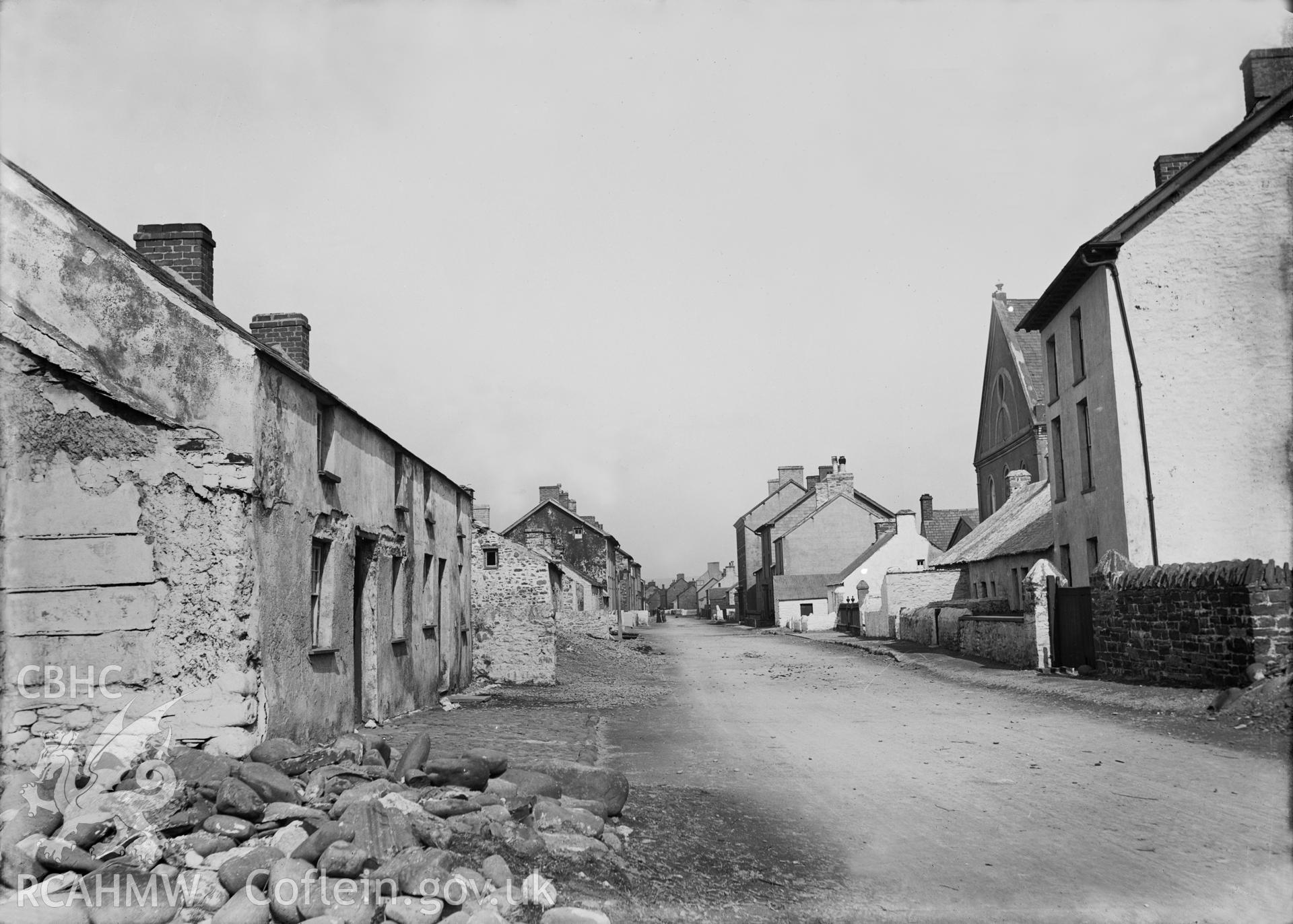 Black and white image dating from c.1910 showing the main street  in Borth.