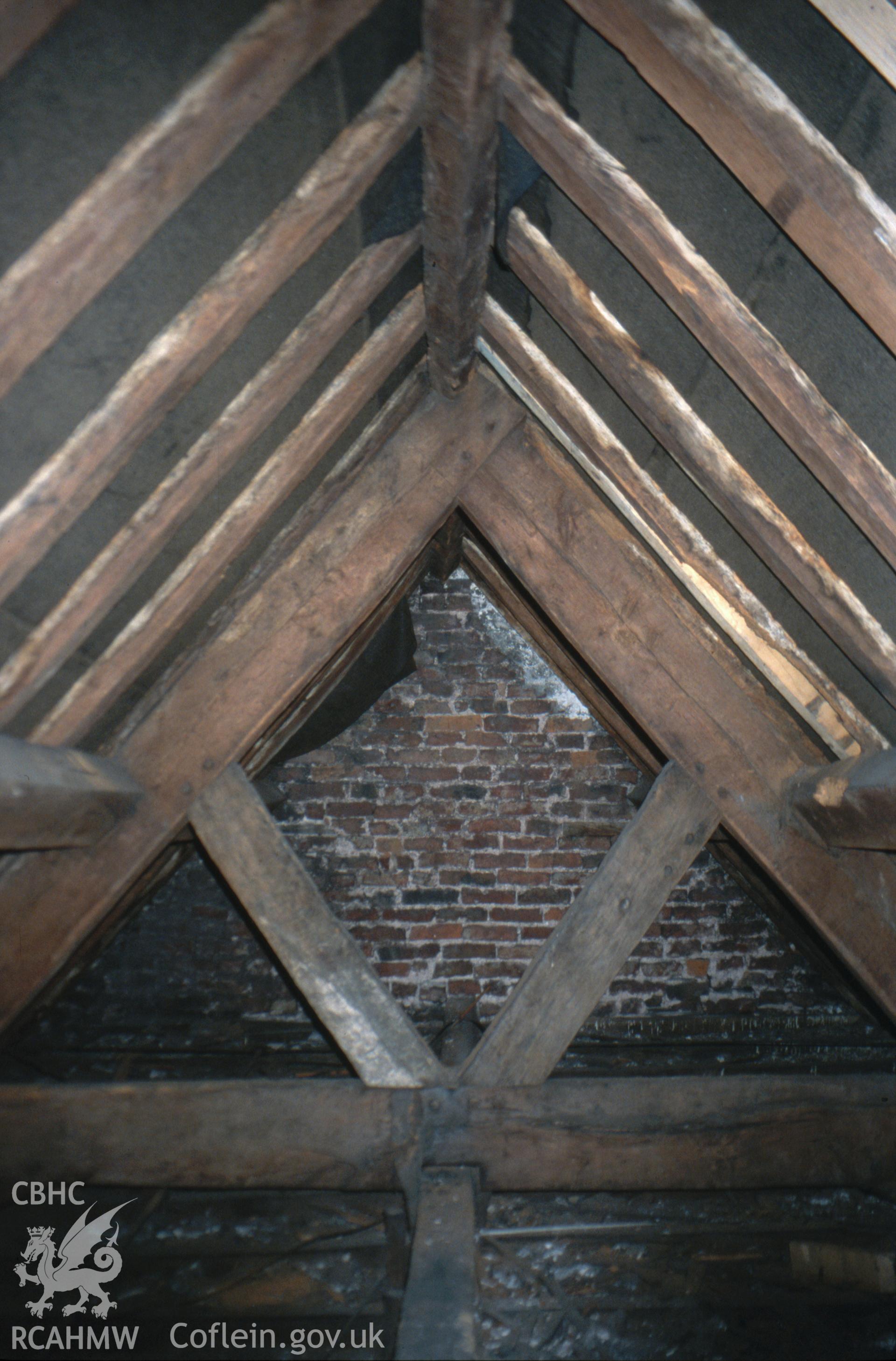 Interior view showing the arched-braced truss in 1666 brick wing.