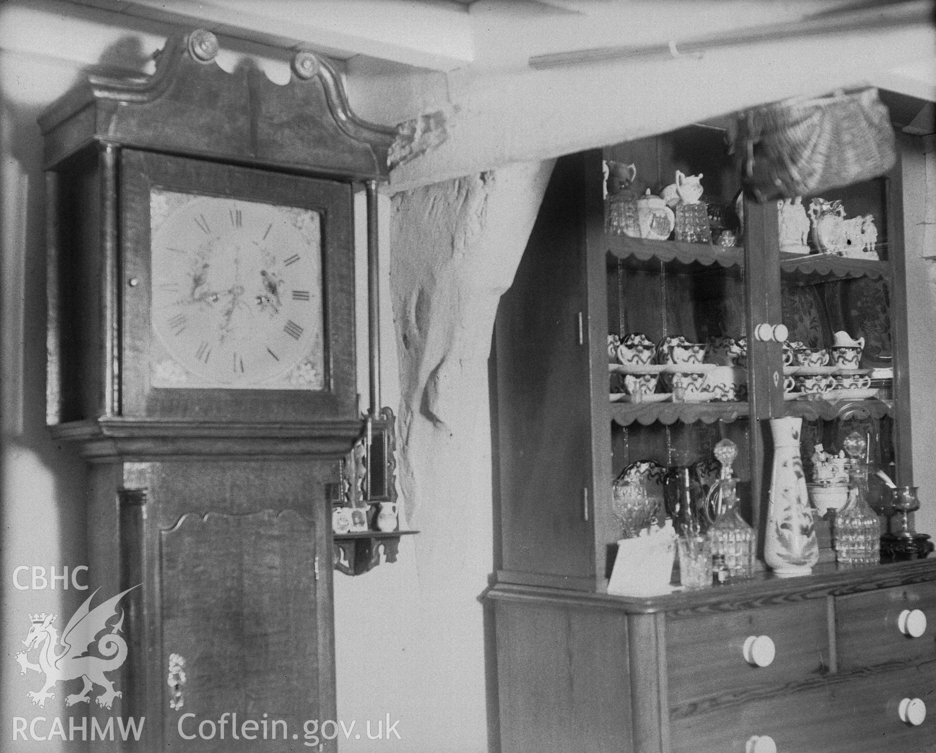 Black and white photograph of Blaen y Glascwm, an interior view showing the base of the west cruck on the south wall and items of furniture, taken by RCAHMW, Dec 1949.