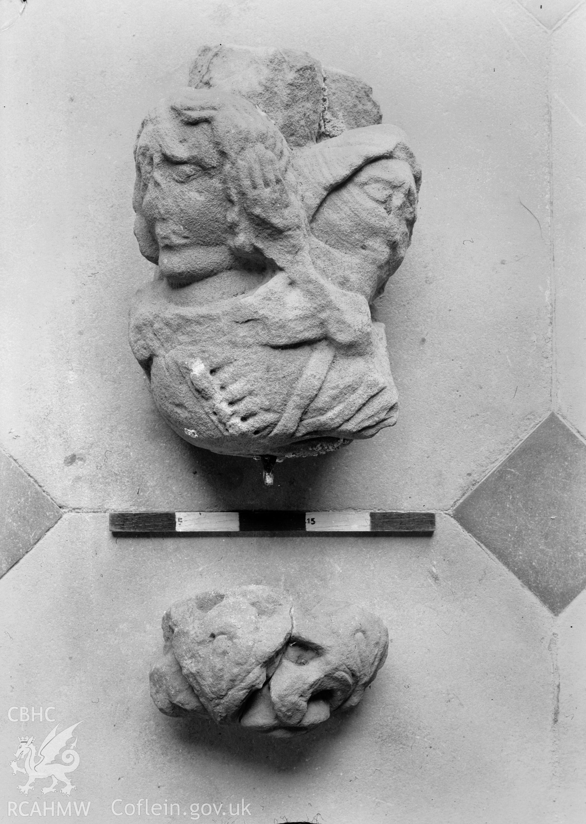 View of stone find of sculpted faces at Maenan Abbey, Caernarfonshire, taken 02.07.1950.