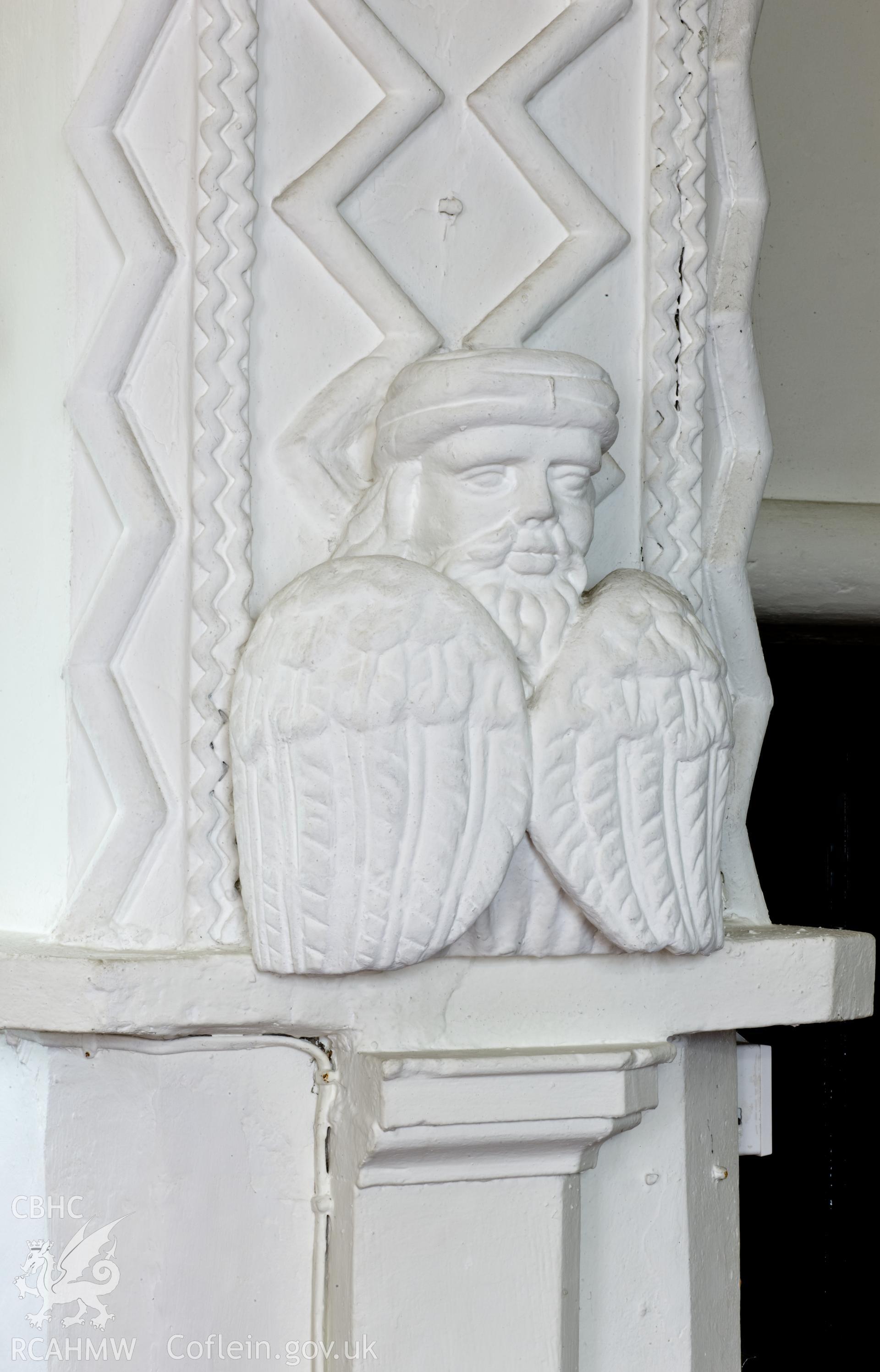 Plaster figure on north base of chancel arch.