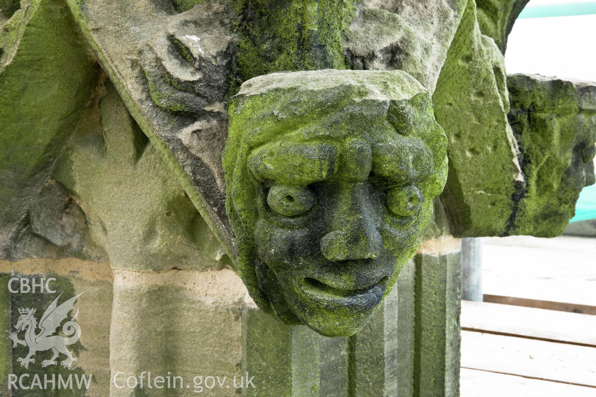 Carved heads on bases of finials, four to a base, moving clock-wise.