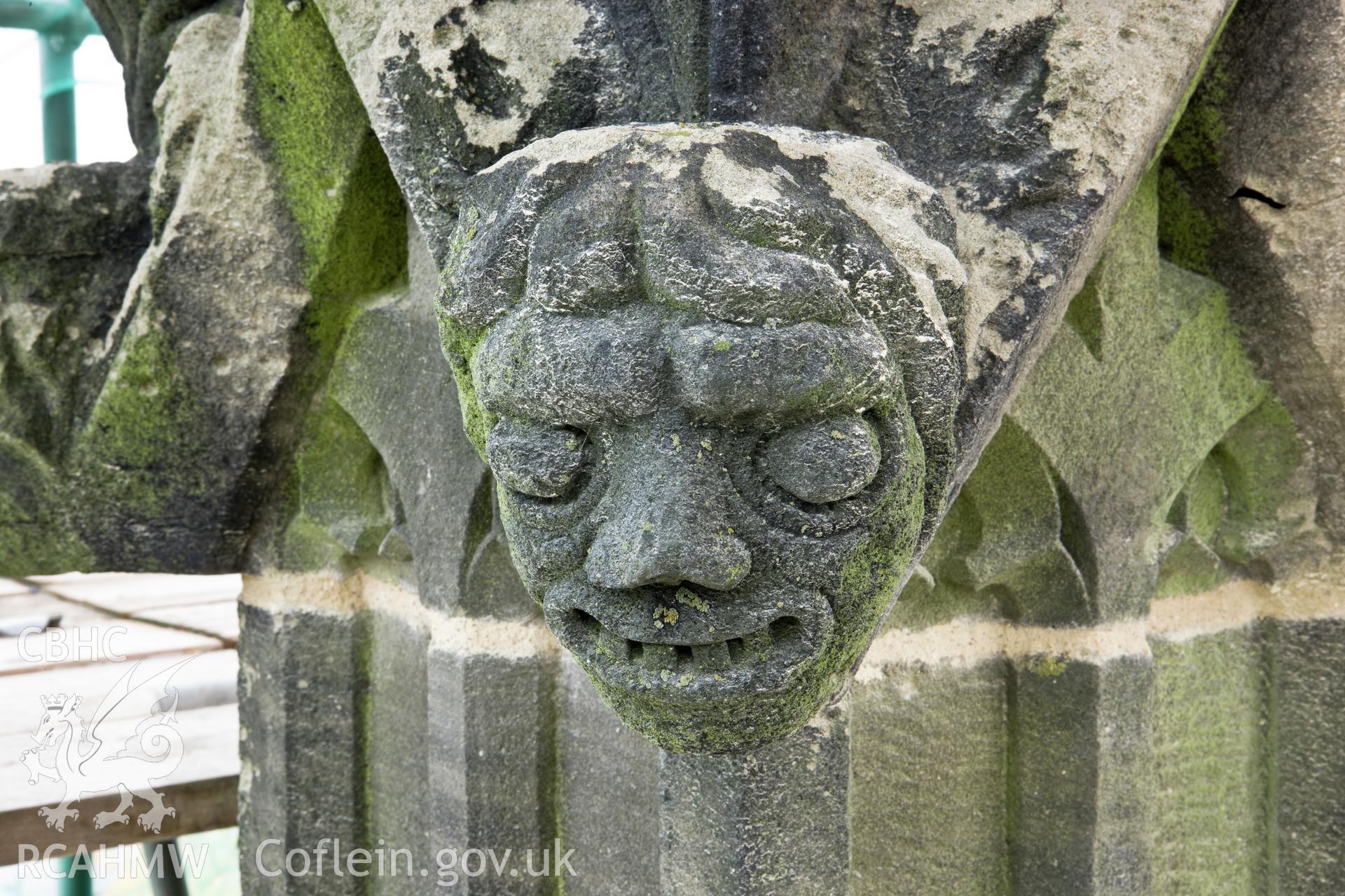 Carved heads on bases of finials, four to a base, moving clock-wise.