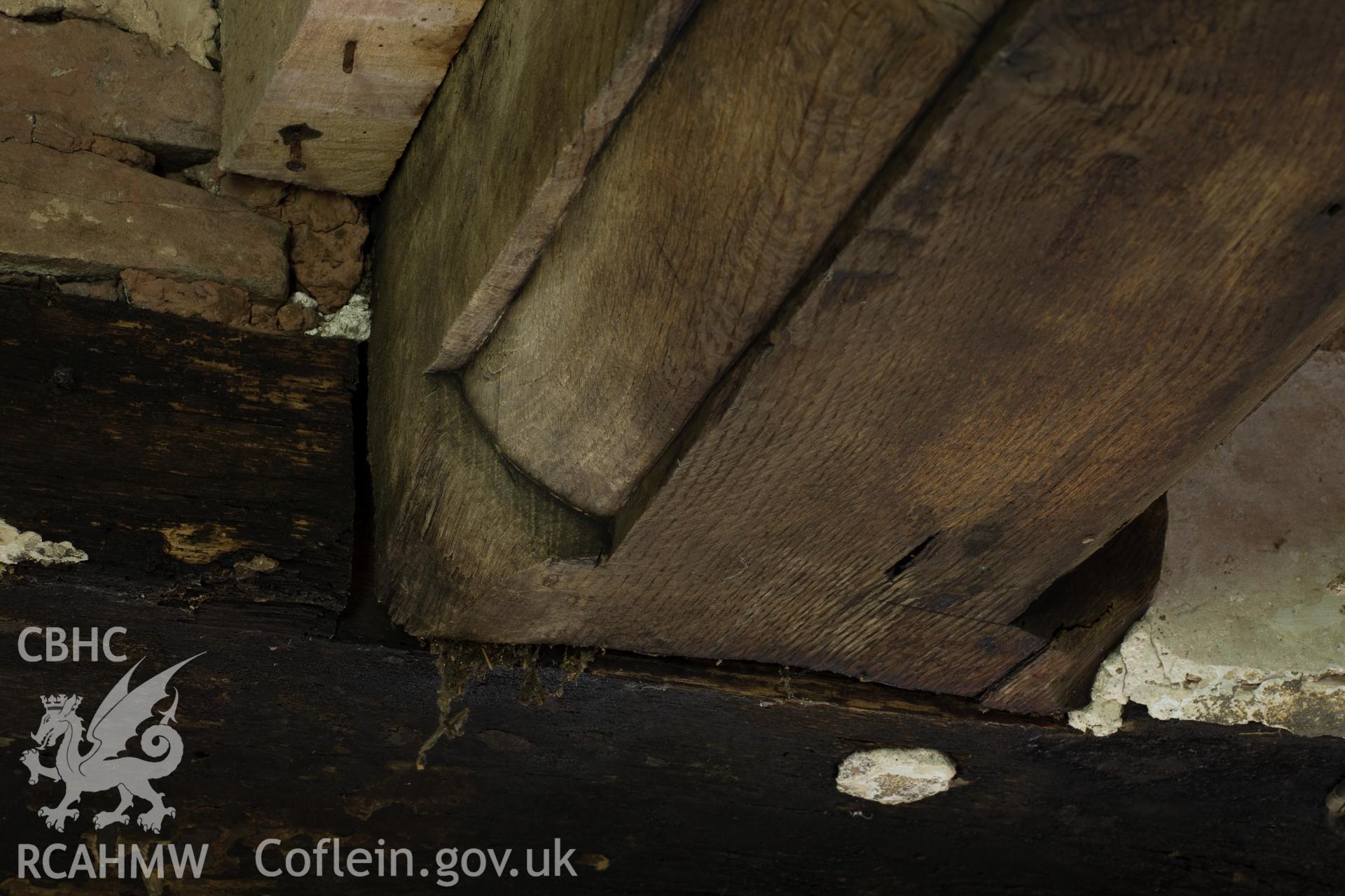 Richly moulded beam over doorway in principal room.