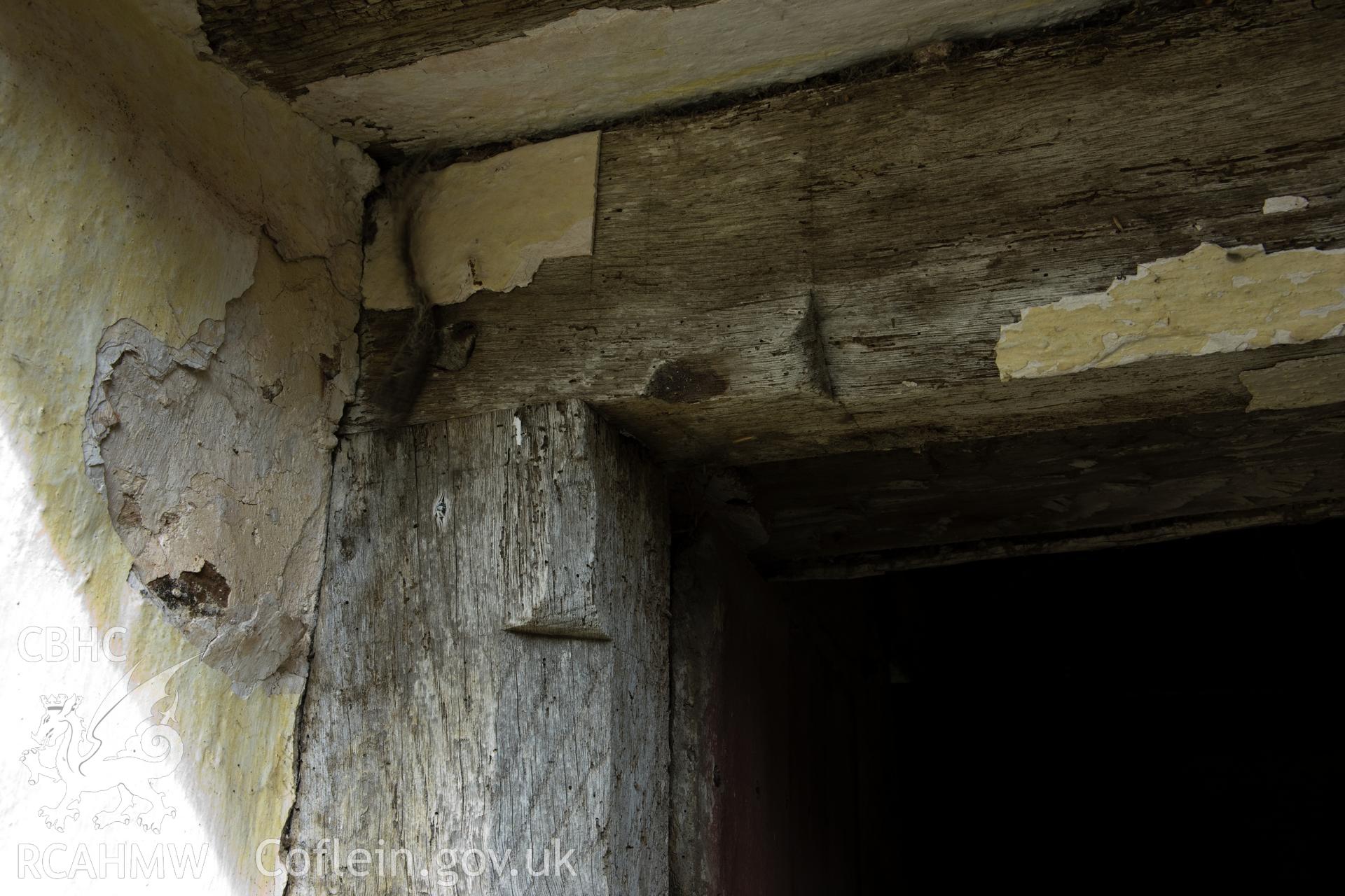 Moulding detail on doorframe to left of chimney in west facade.