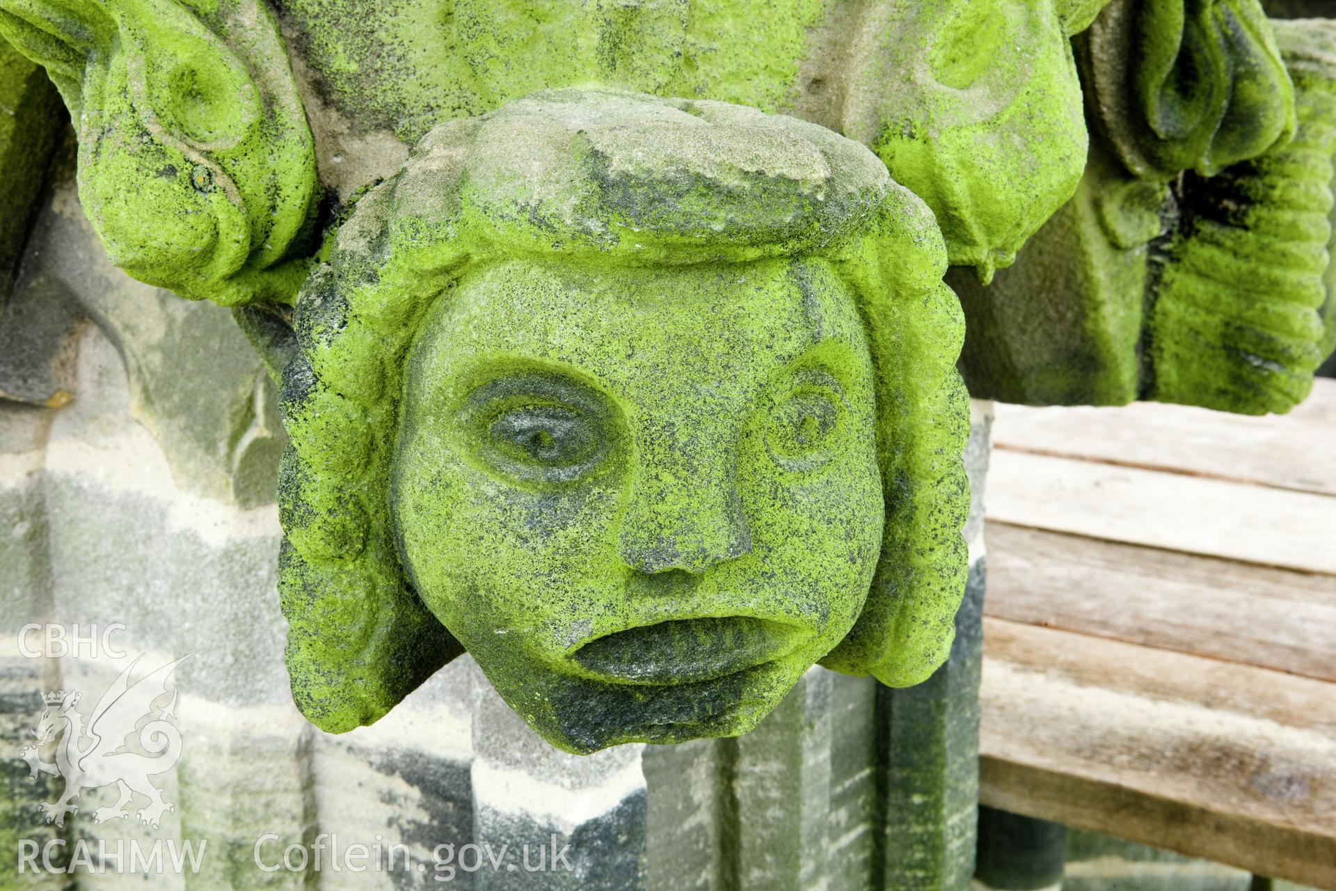 Carved heads on bases of finials, four to a base, moving clock-wise.