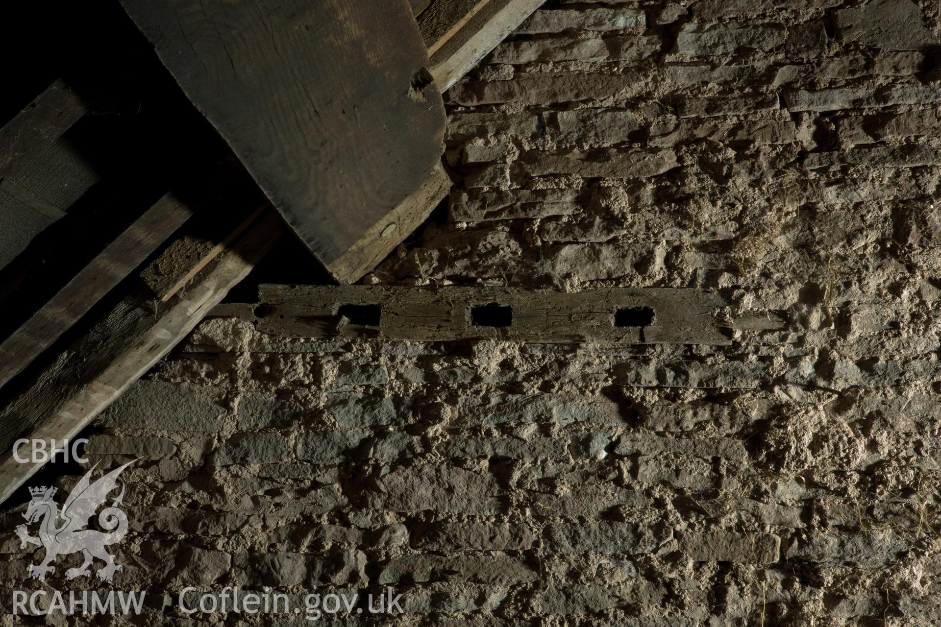 Re-used window framing in east wall (left).