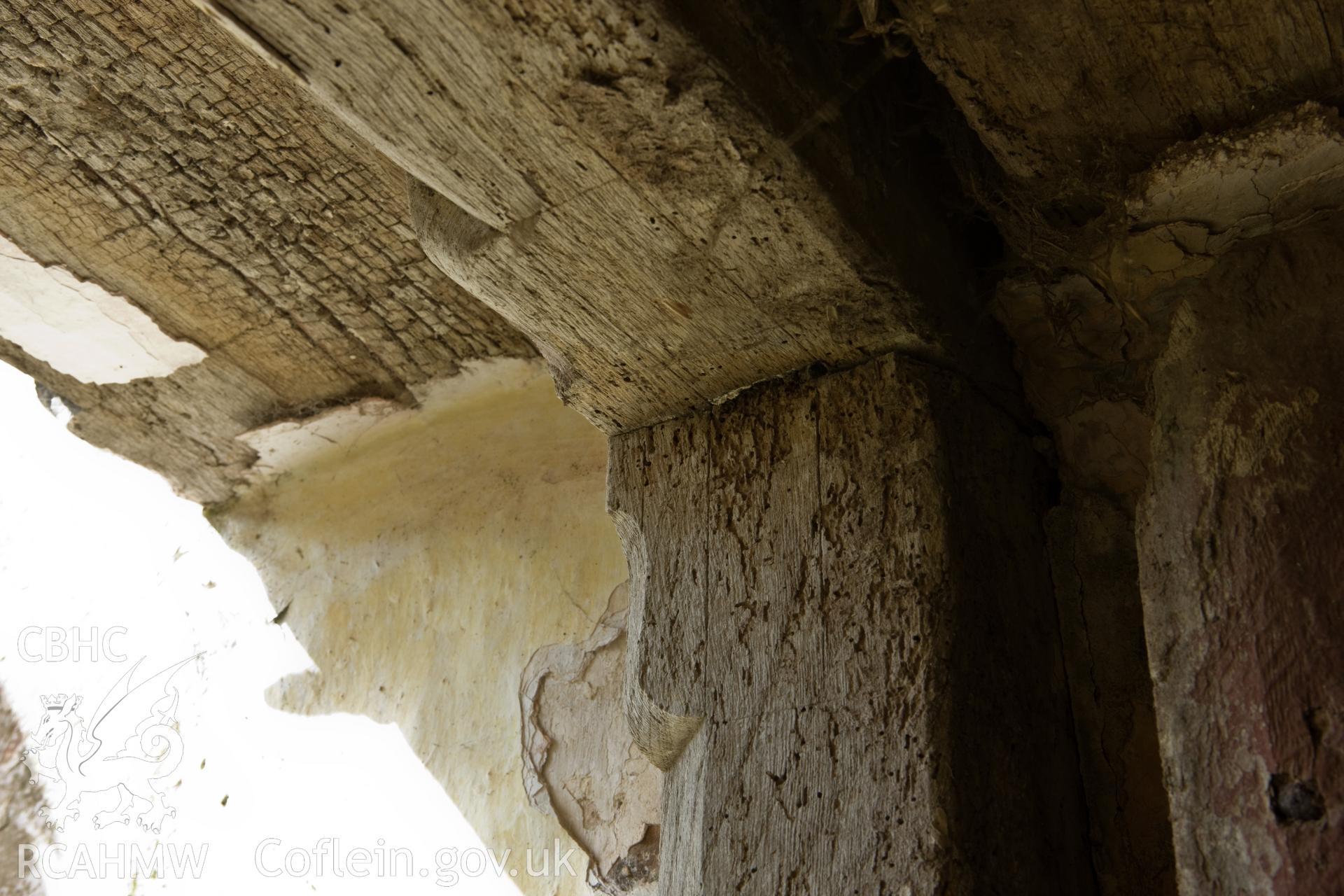 Moulding detail on doorframe to left of chimney in west facade.