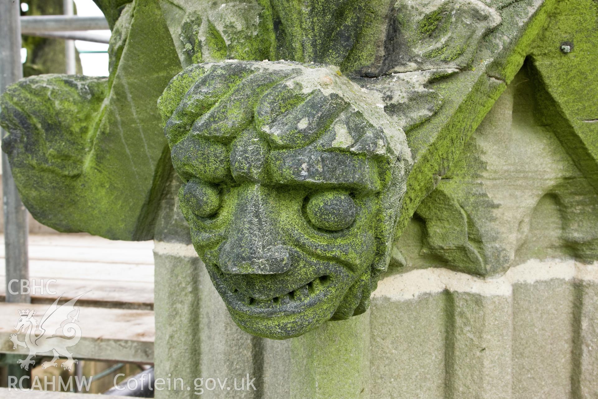 Carved heads on bases of finials, four to a base, moving clock-wise.