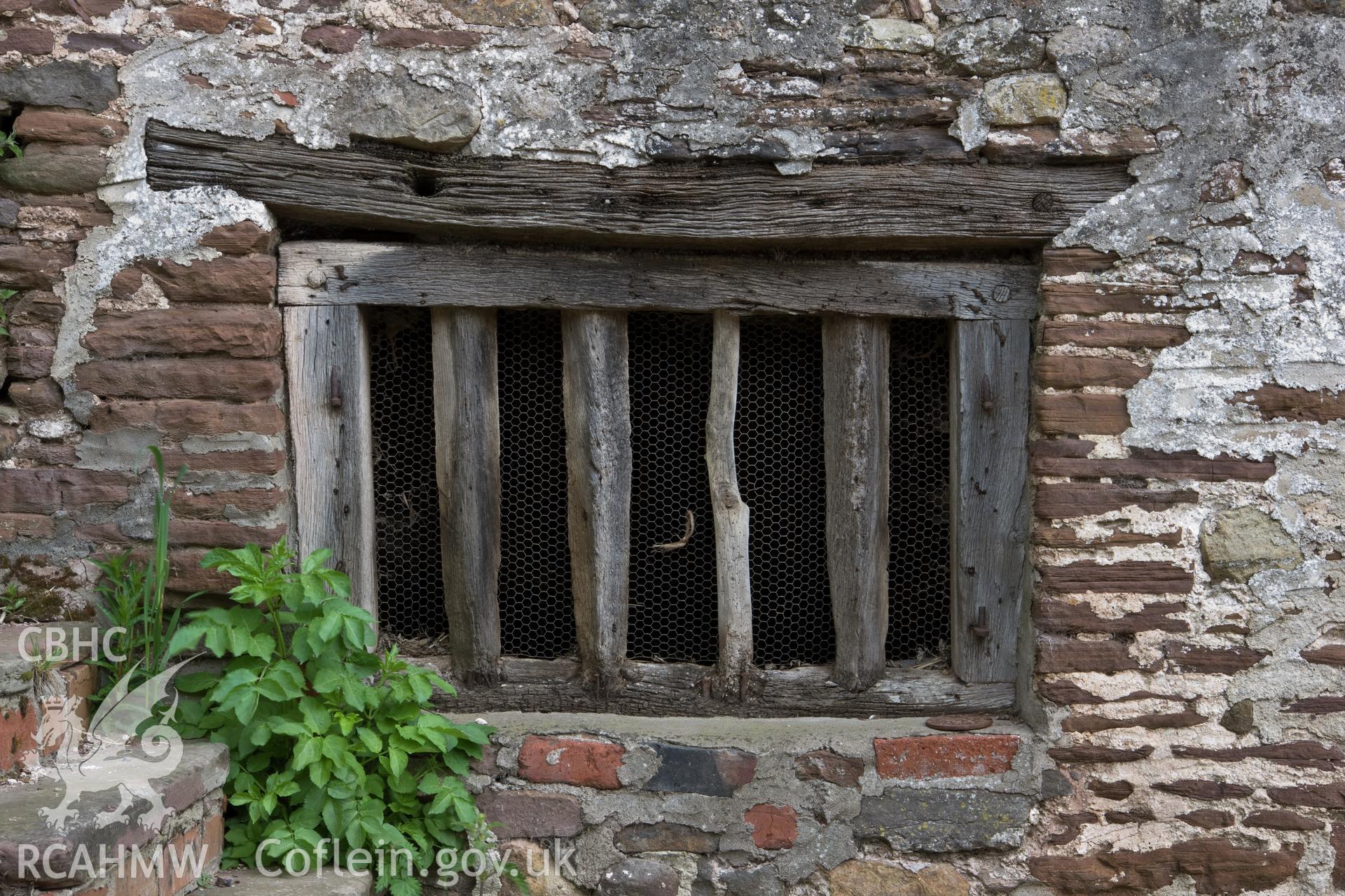 Rough mullion window into ground floor of granary.