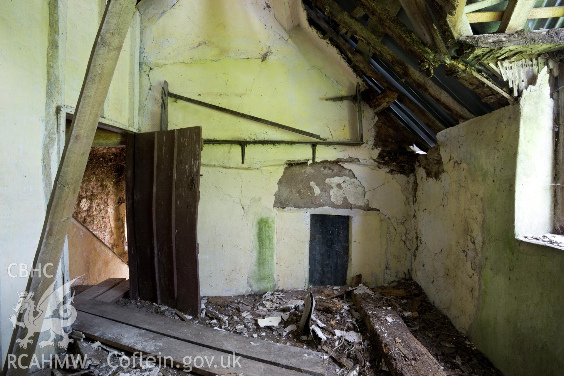 Bedroom on northwest, with massive stone lintel over fireplace.