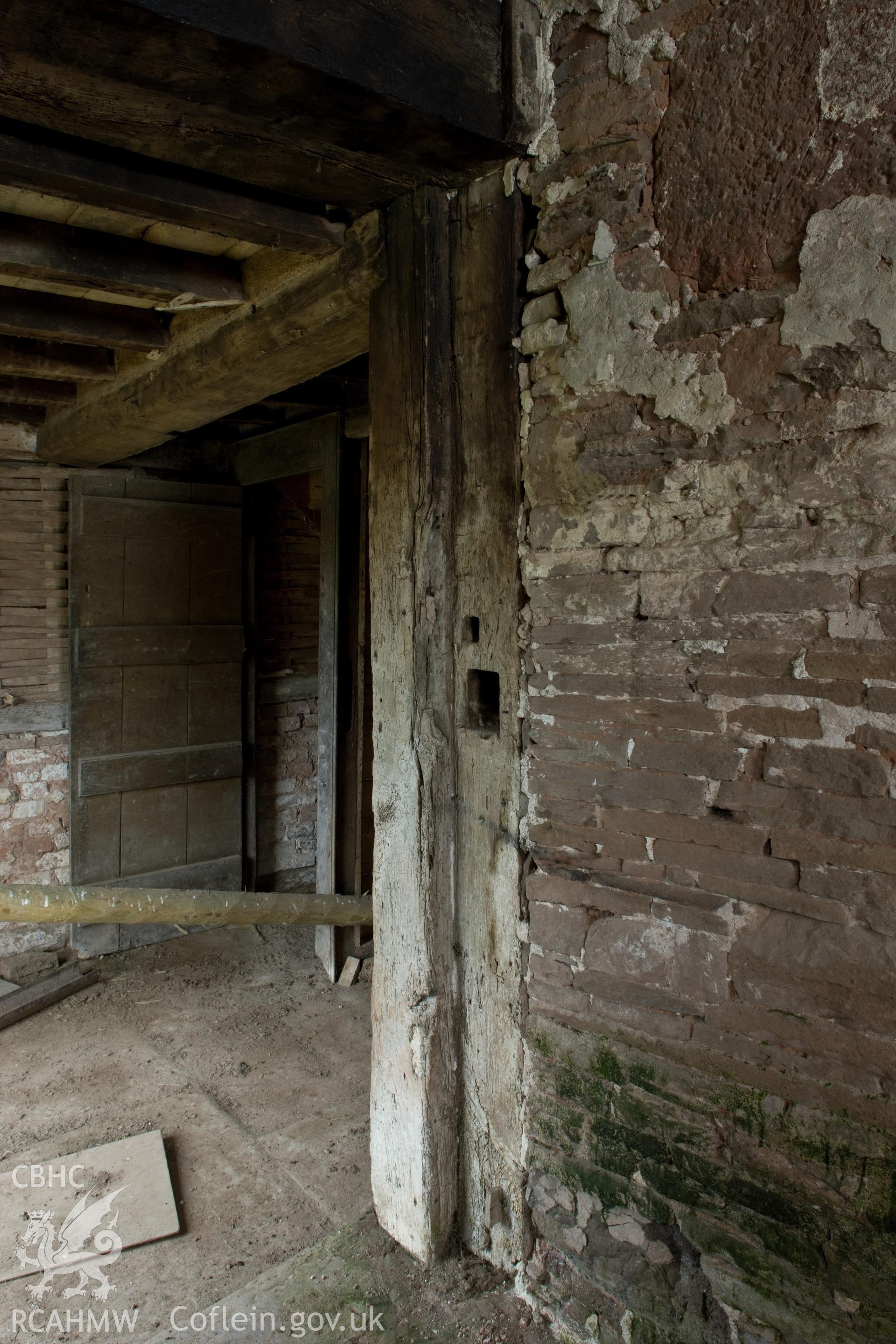 Massive doorpost with draw bar slot into main chamber.