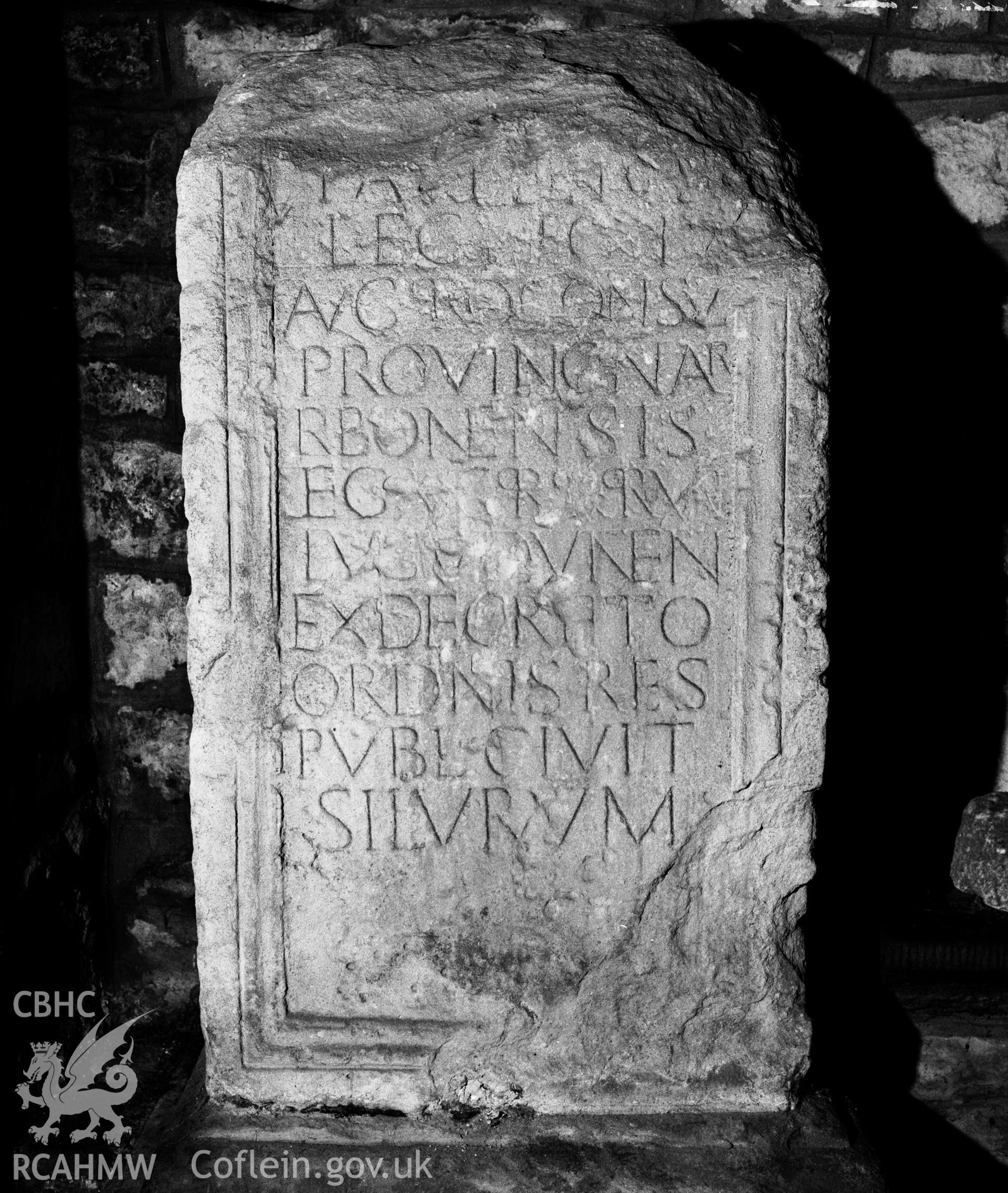 Black and white photograph showing the Silurum or Paulinus Stone at St Stephen's Church, Caerwent.