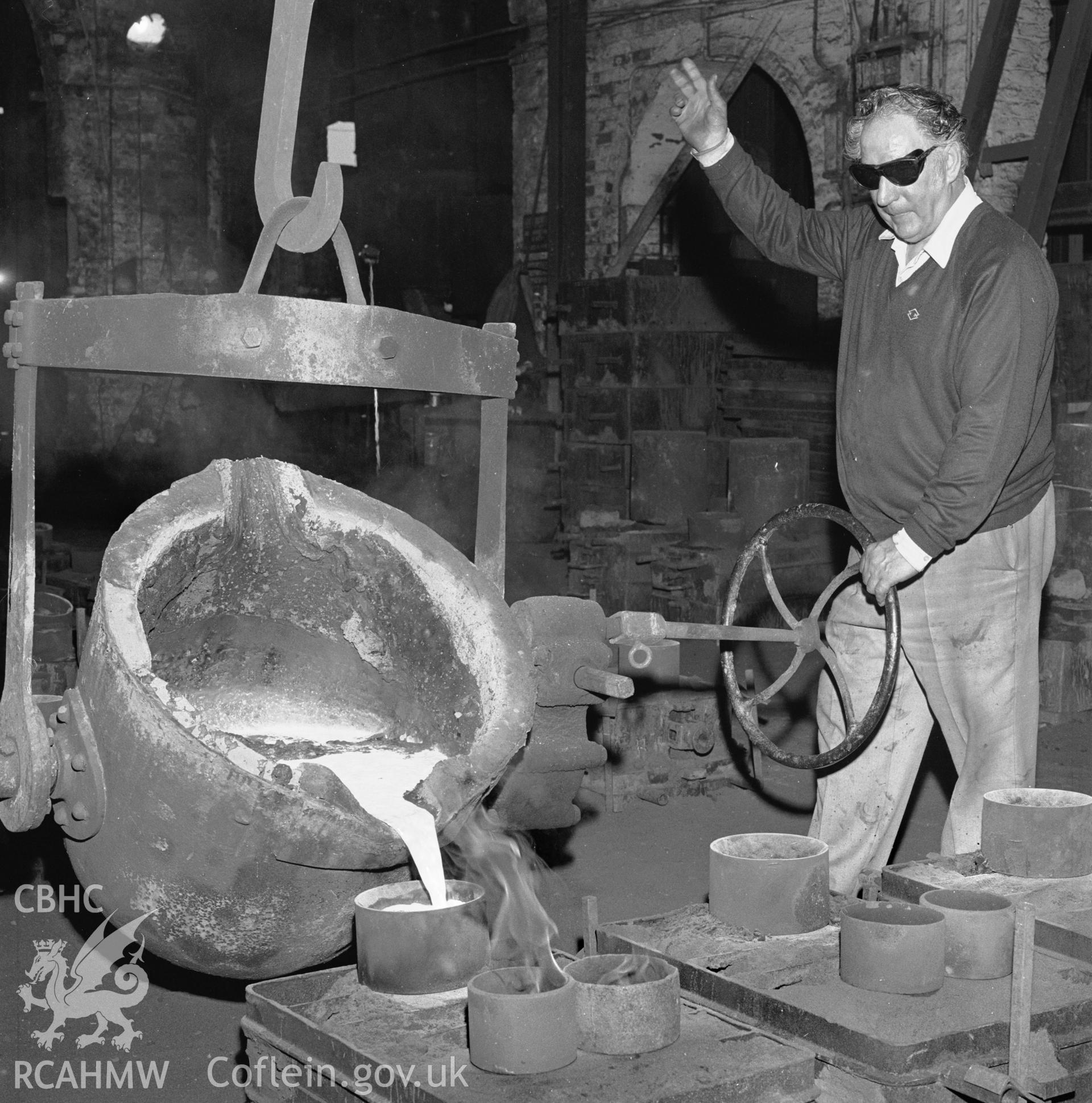 Molten iron being poured into mould boxes