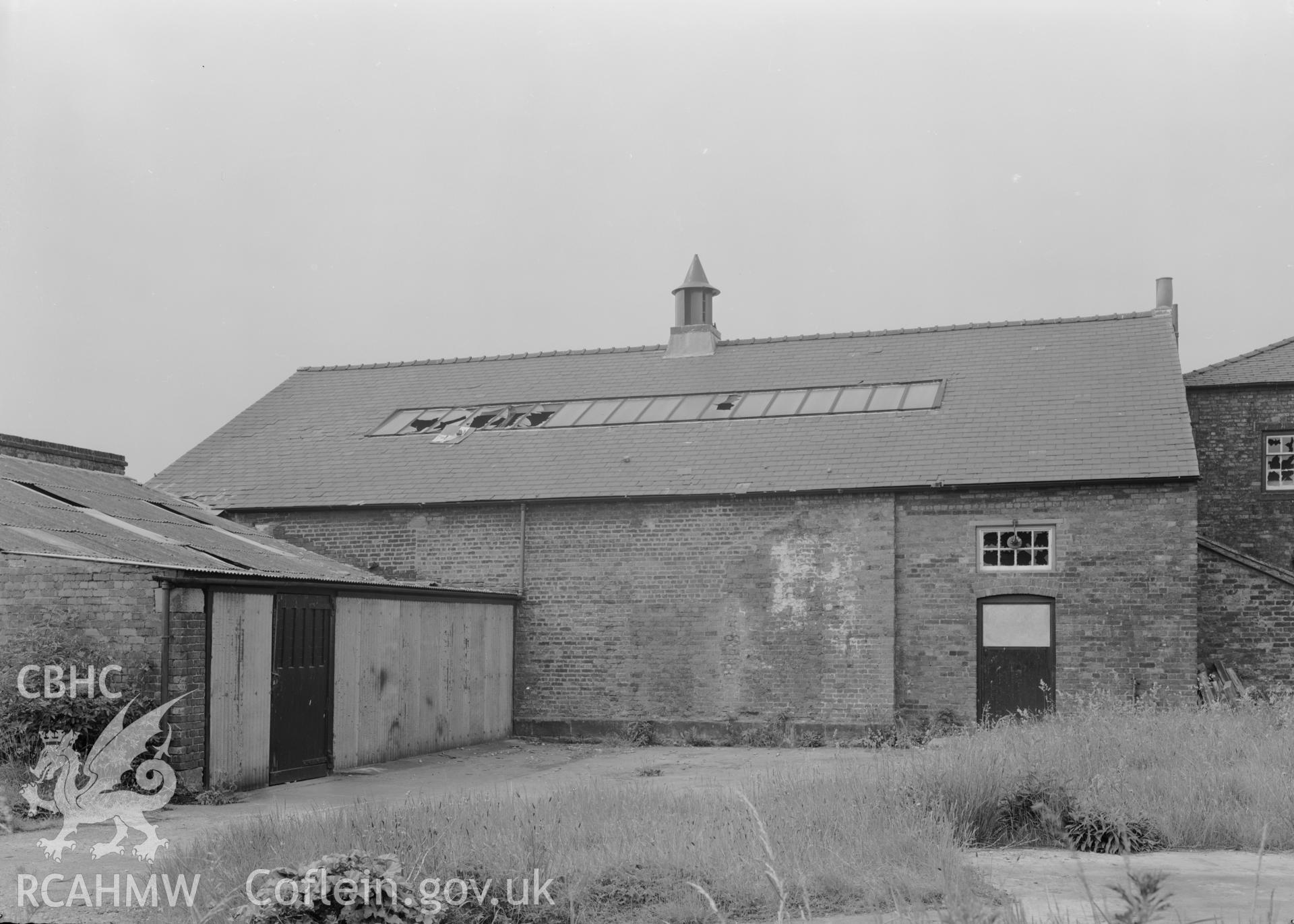 D.O.E photograph of Flint Gaol - rear elevation of drill hall, looking south west. In castle outer ward (since removed).