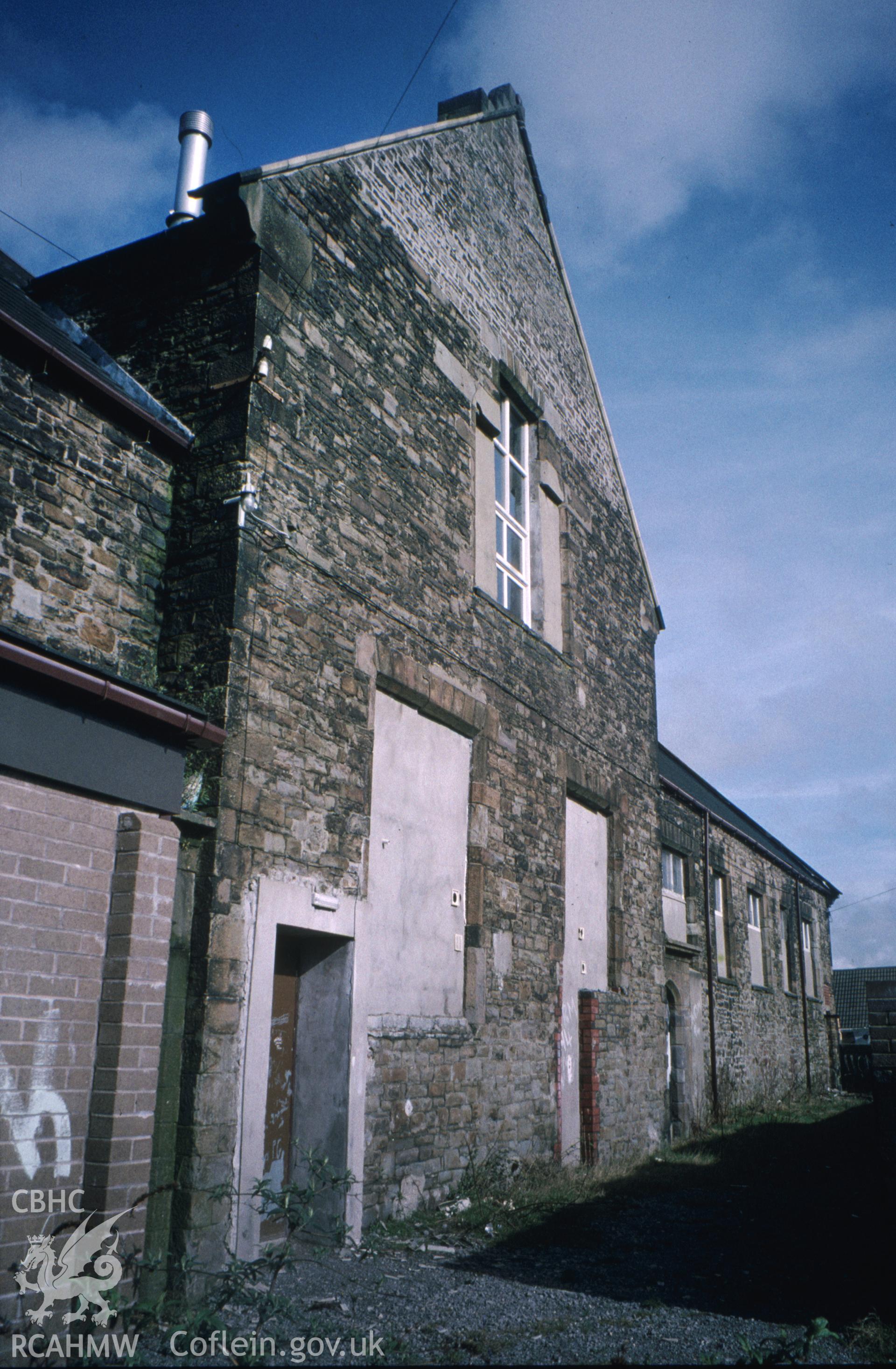 Colour slide of Hafod Copperworks School: showing the south-east playground facade and the central gable from the south-west.