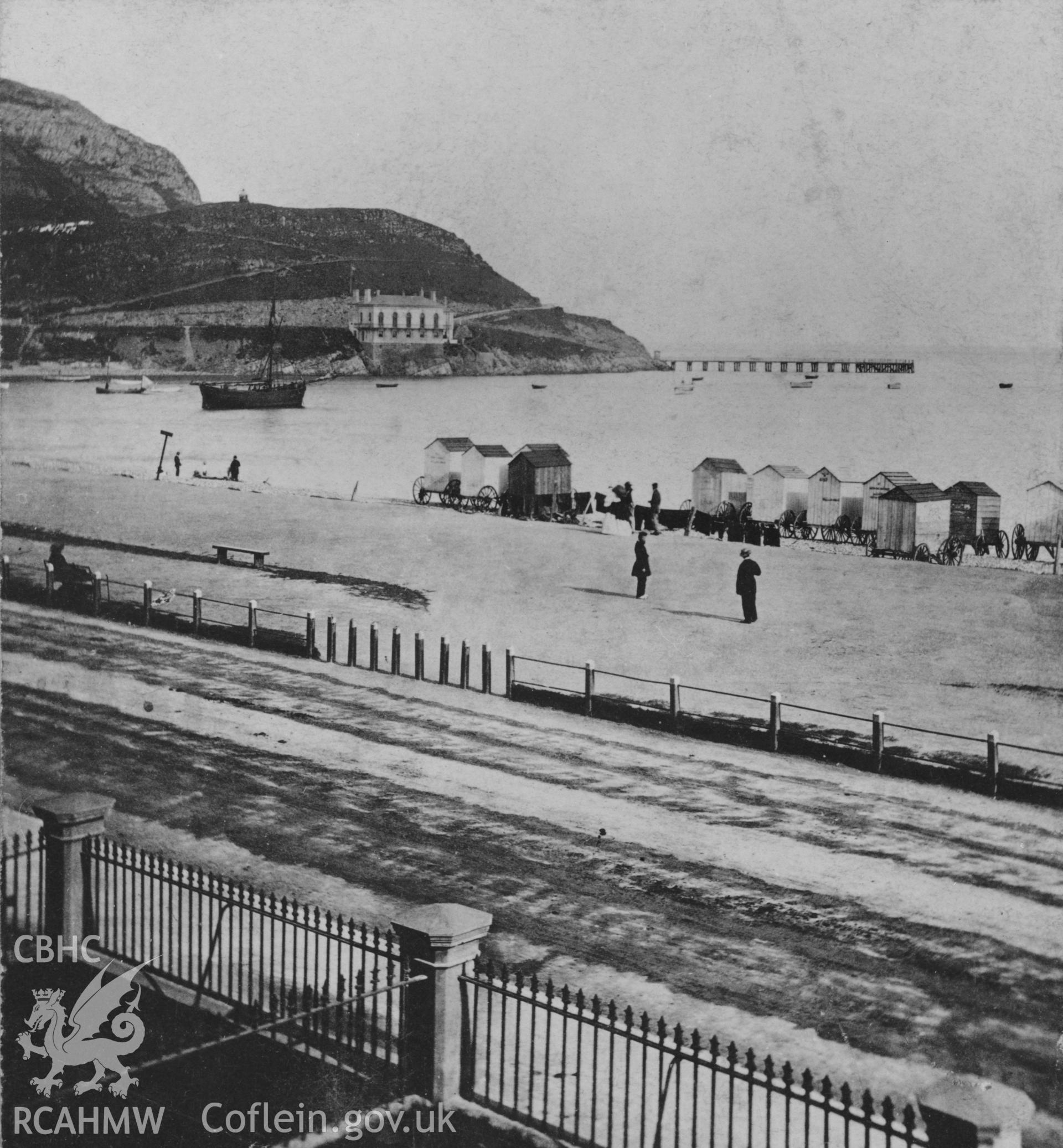 View showing the beach and bathing huts at Llandudno, undated.