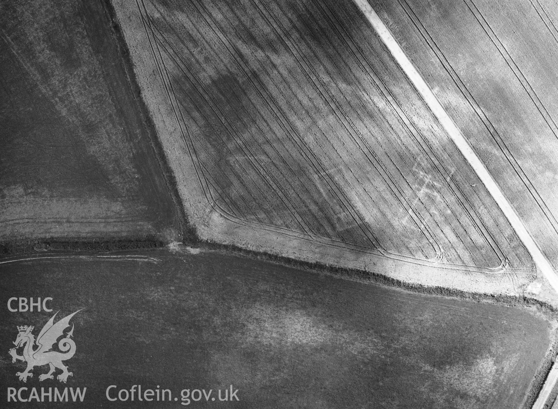 RCAHMW black and white oblique aerial photograph of Croes Carn Einion Villa (Basseleg Villa), taken by C R Musson, 24/07/1996.