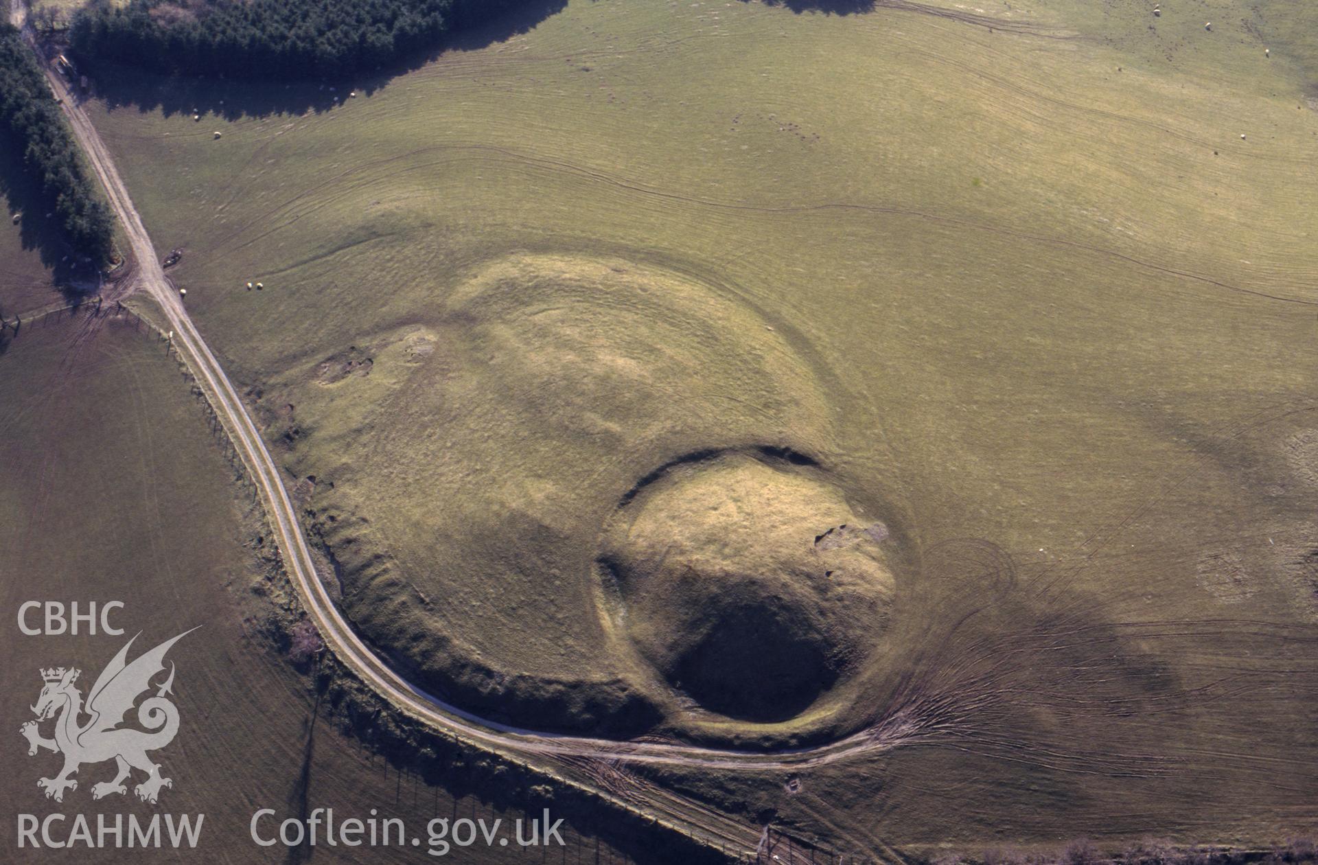 RCAHMW colour slide aerial photograph of Tomen Bedd Ugre. Taken by C R Musson on 23/03/1995