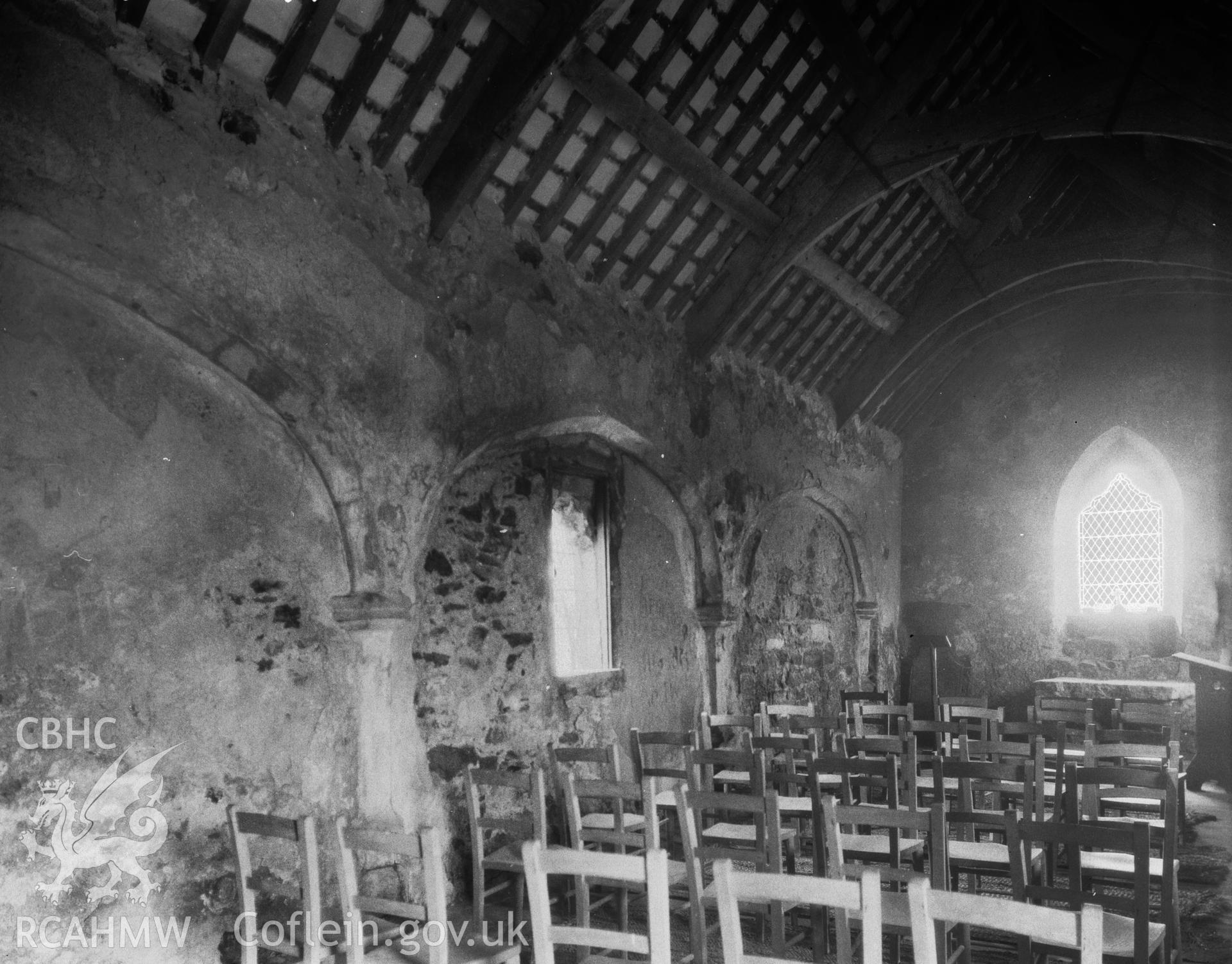 Digitised copy of a black and white negative showing interior of St Cwyfan's Church, produced by RCAHMW before 1960
