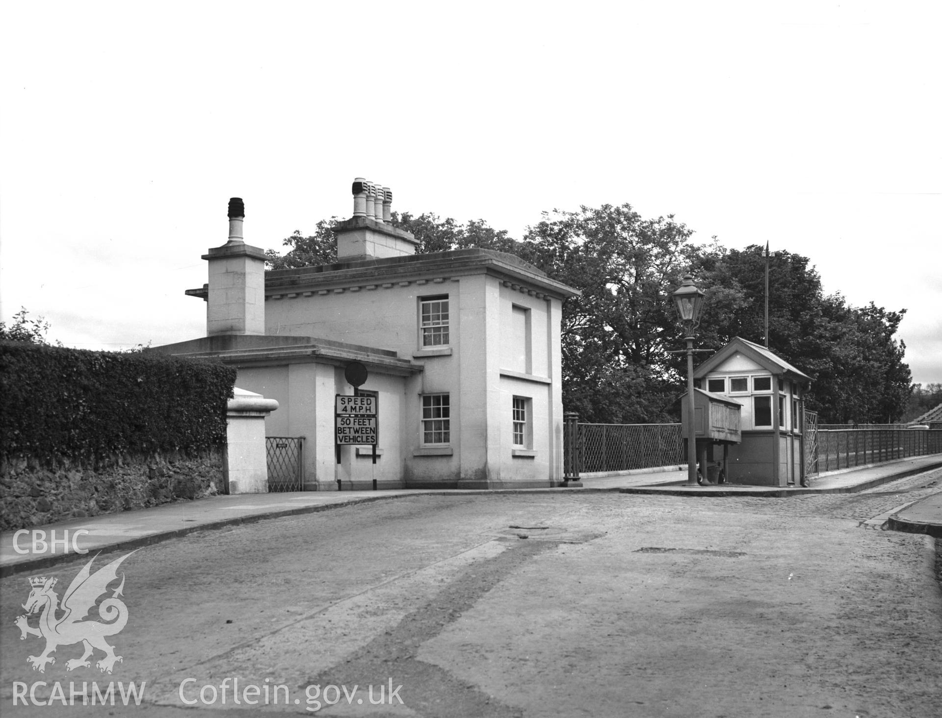 Digitised copy of a black and white negative showing the Toll House at Menai Suspension Bridge, produced by RCAHMW, before 1960.