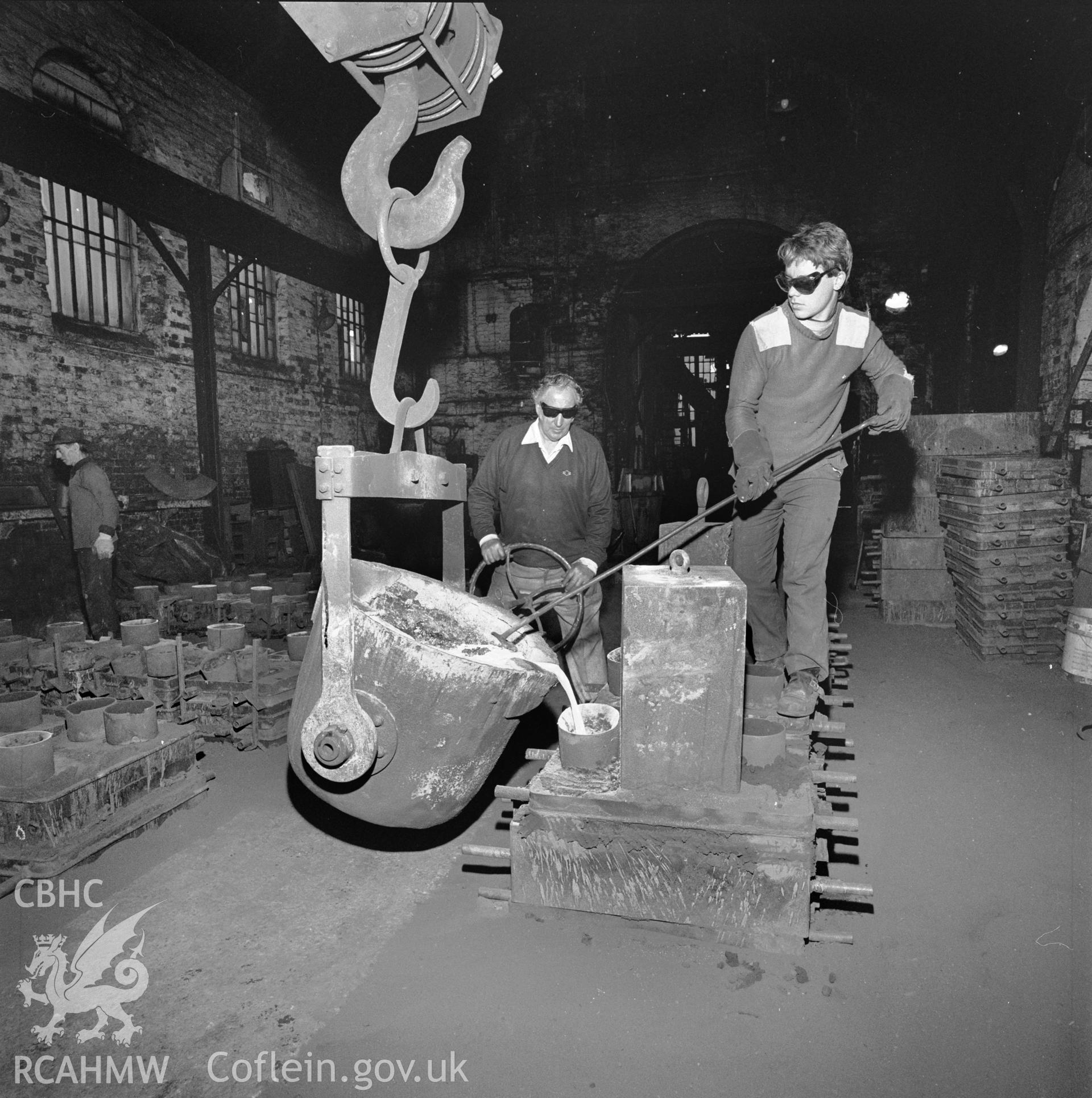 The ladle, moved by gantry is being tilted, and the molten iron poured into mould boxes