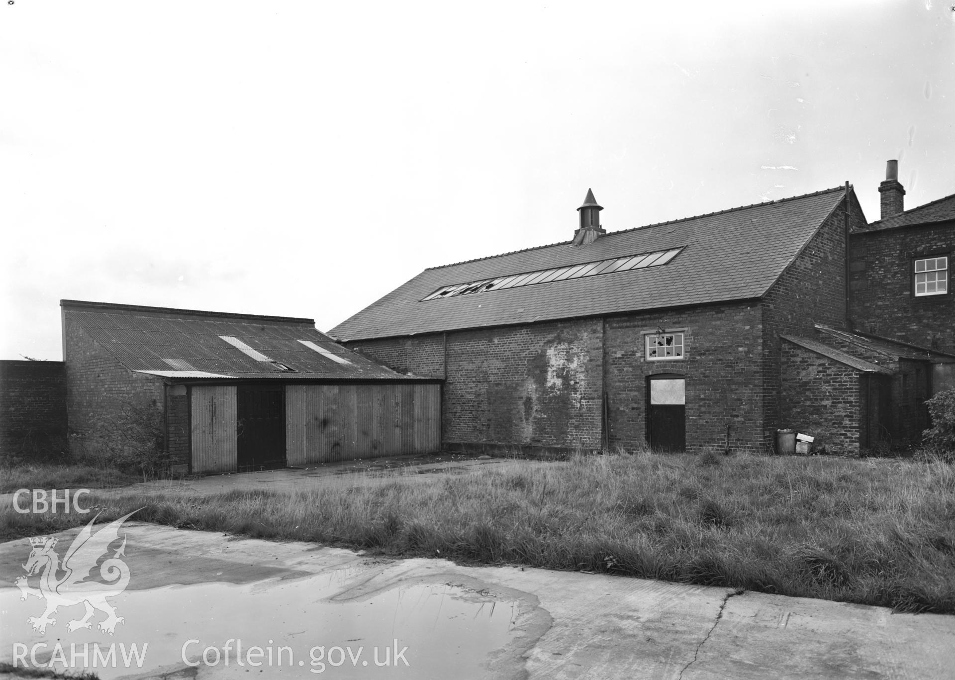 D.O.E photograph of Flint Gaol drill hall and garage, looking north. In castle outer ward (since removed).