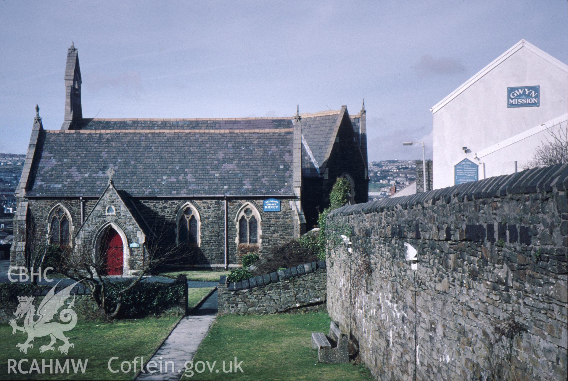 Colour slide of All Saints, Kilvey Road, Swansea: showing copper-slag coping on the south-east side, and the Gwyn Mission to the right of the photograph.