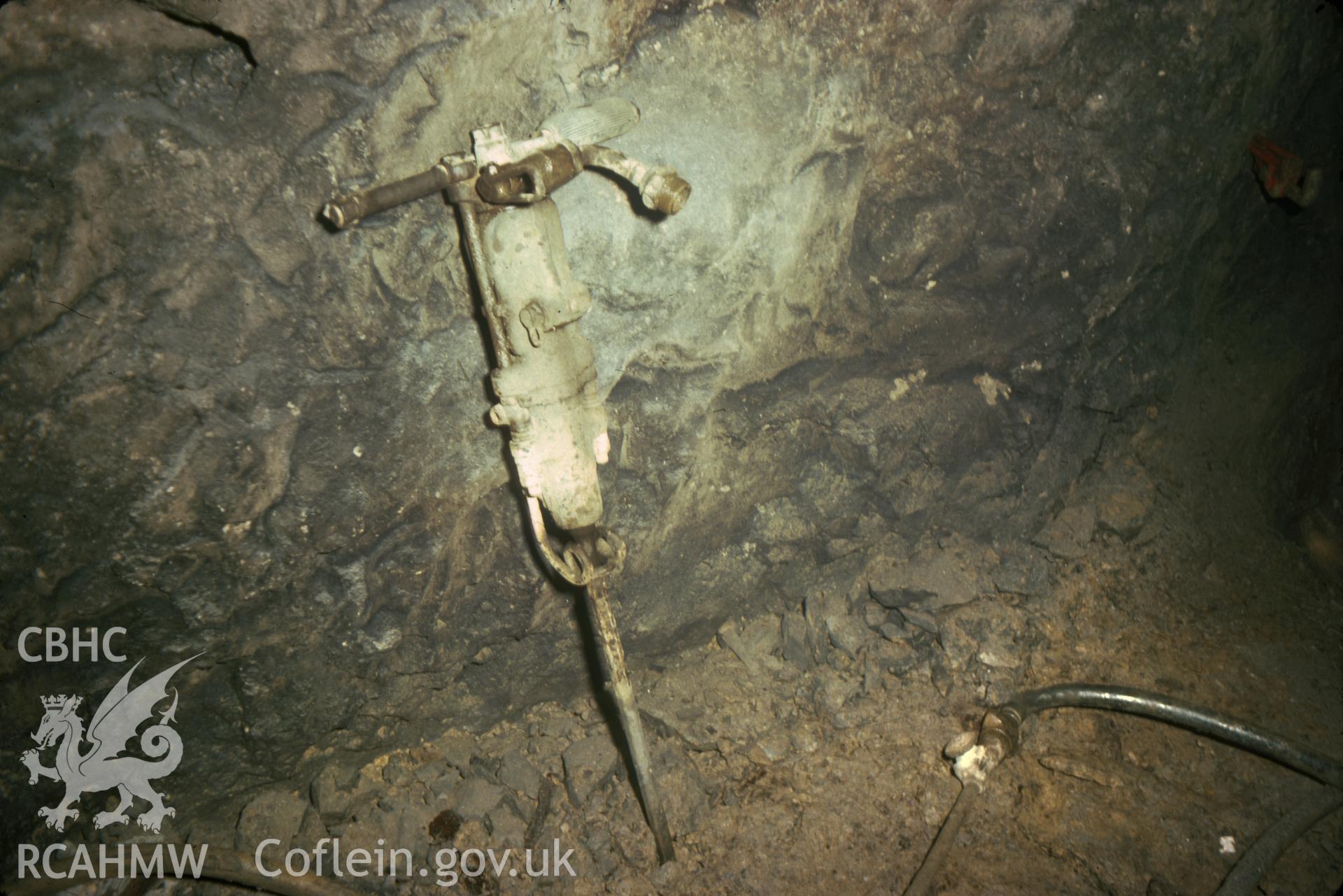 Digitized 35mm slide of Milwr Tunnel, Halkyn, showing men working in Lode 621 with a drill.