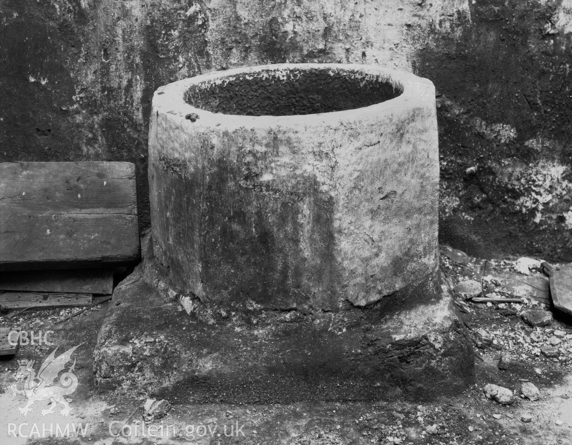Black and white photographic print of the font at St Fflewyn's Church, Llanfflewyn.