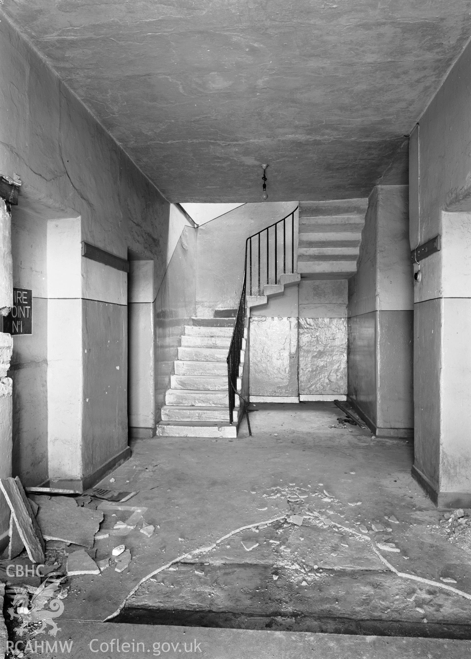 D.O.E photograph of Flint Gaol - hall in main block showing stairs and old paving slabs, looking north east. In castle outer ward (since removed).