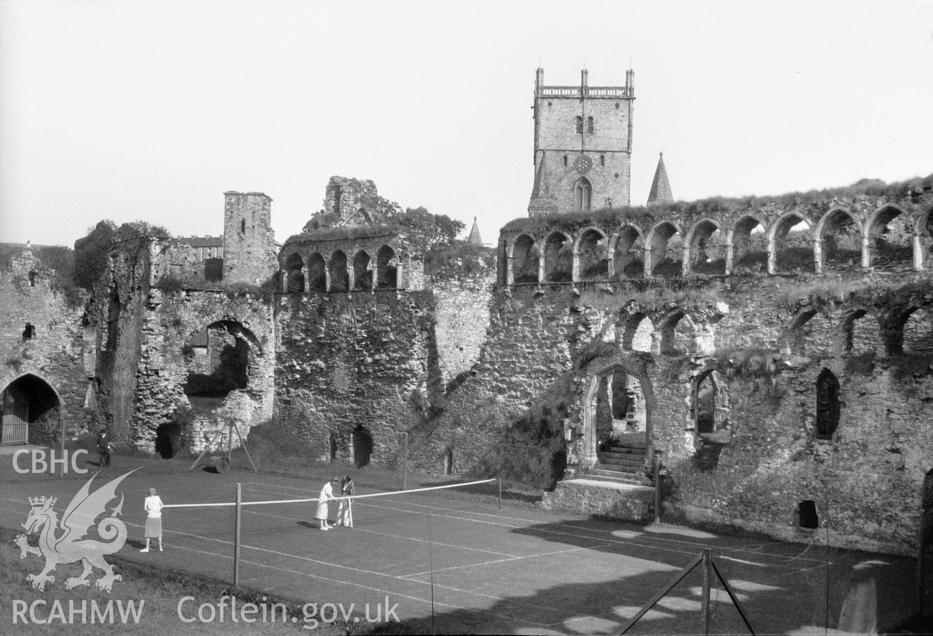 A black and white print of the Bishops Palace, St Davids, showing tennis game in the foreground. Taken by Miss Wight, c.1934