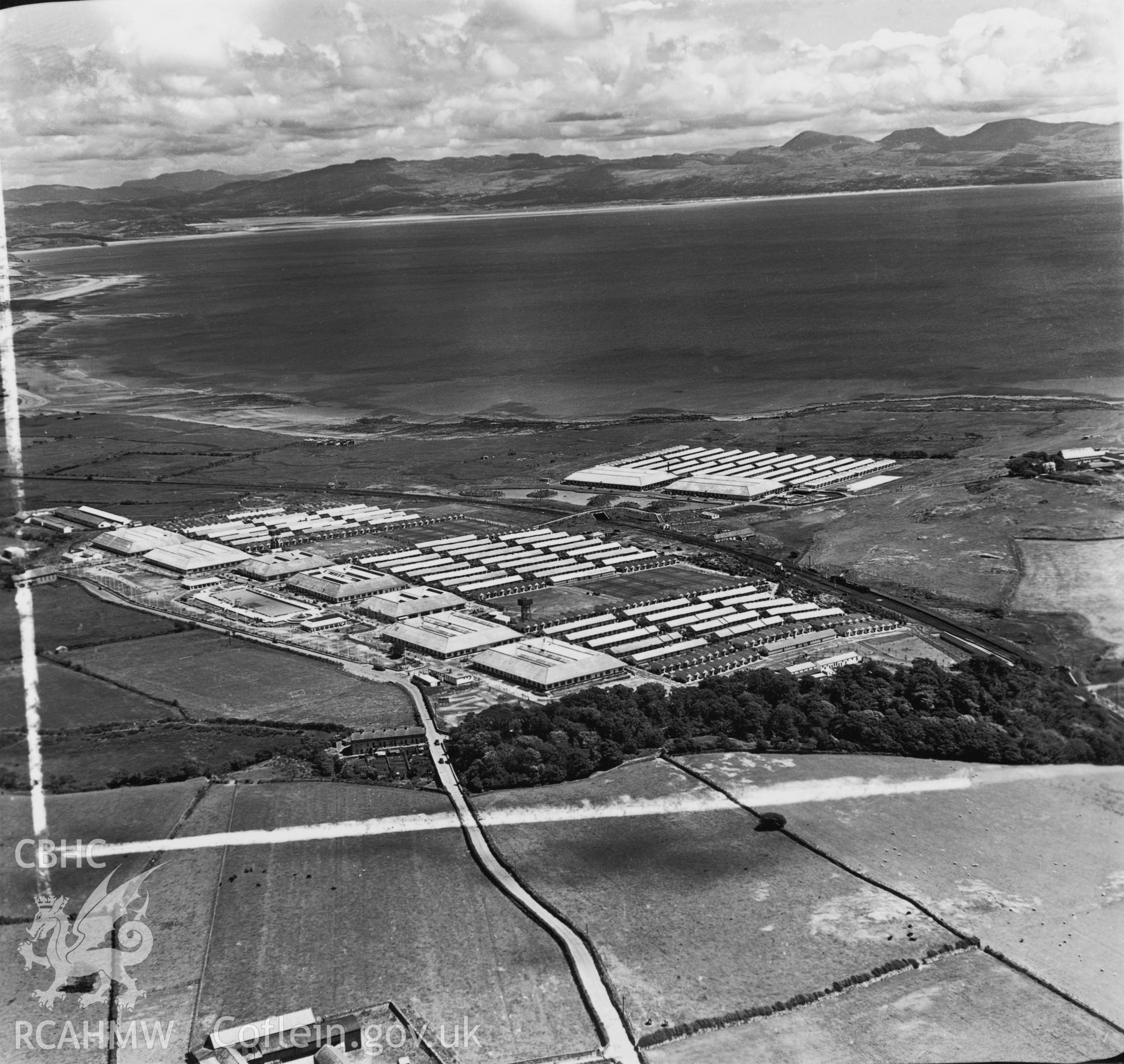 Black and white oblique aerial photograph showing Butlins Holiday Camp, Pwllheli from Aerofilms album Caernarvonshire Lland-Z, taken by Aerofilms Ltd and dated 15th June 1950