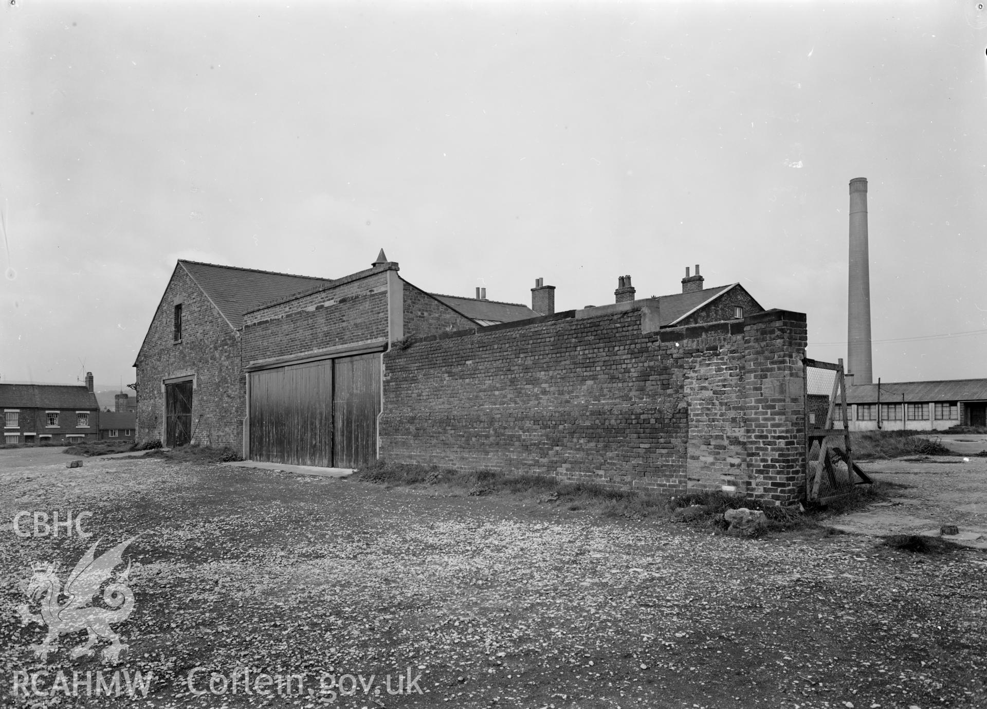 D.O.E photograph of Flint Gaol - south east elevation of drill hall and garages, from east. In castle outer ward (since removed).