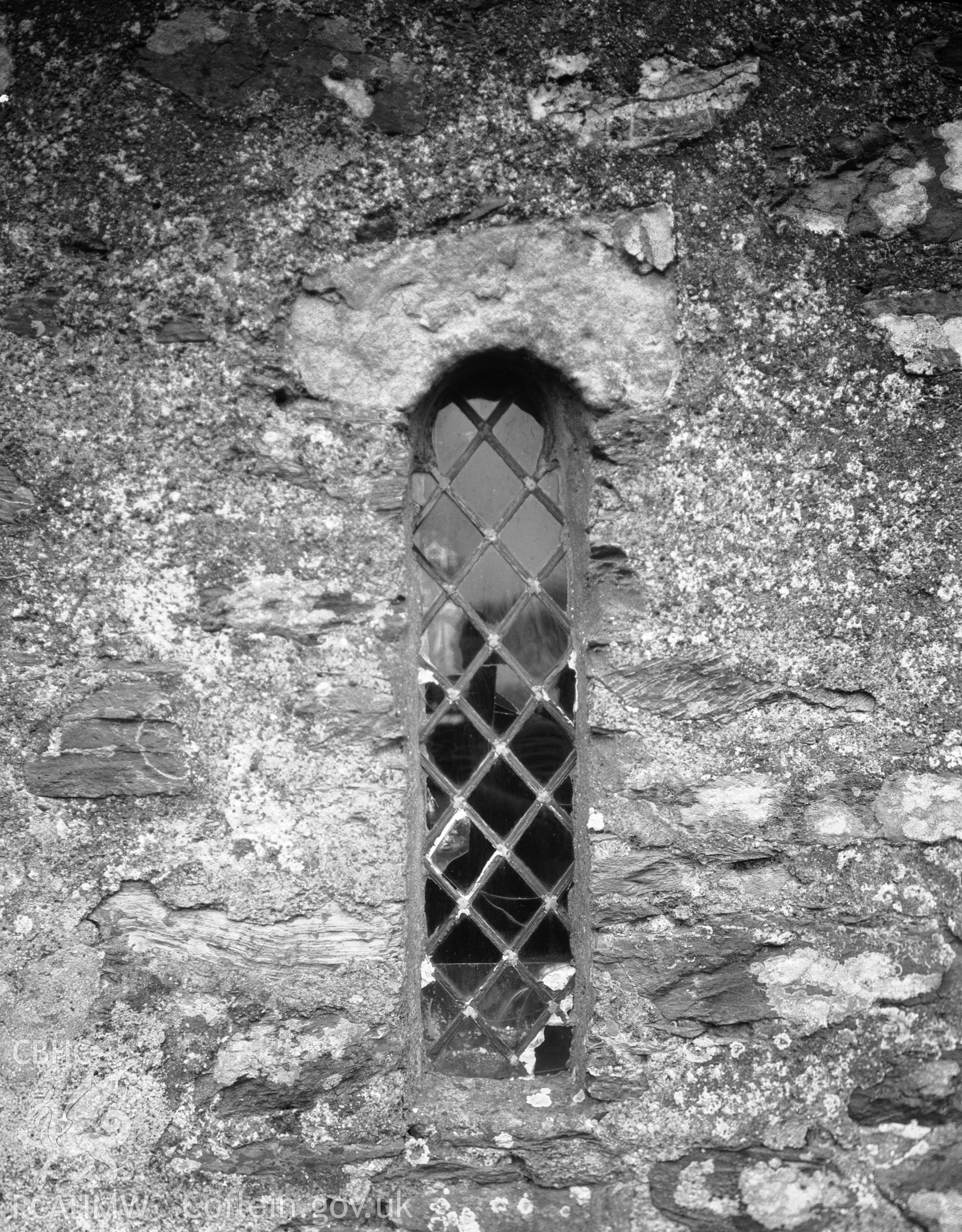 Digitised copy of a black and white negative showing a window in St Mechell's Church, produced by RCAHMW, pre1960.