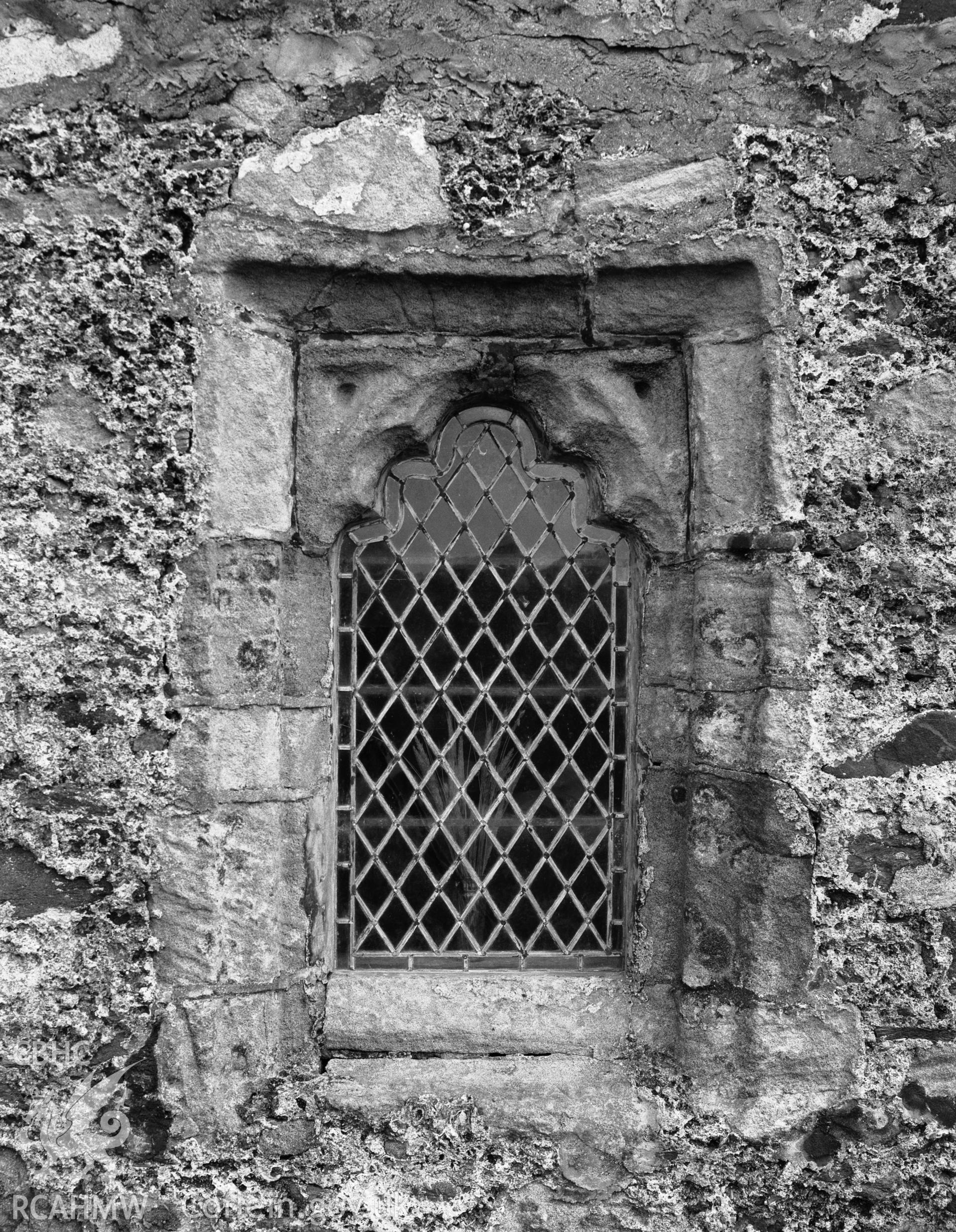 Digitised copy of a black and white negative showing fifteenth-century window at St Cwyfan's Church, produced by RCAHMW before 1960