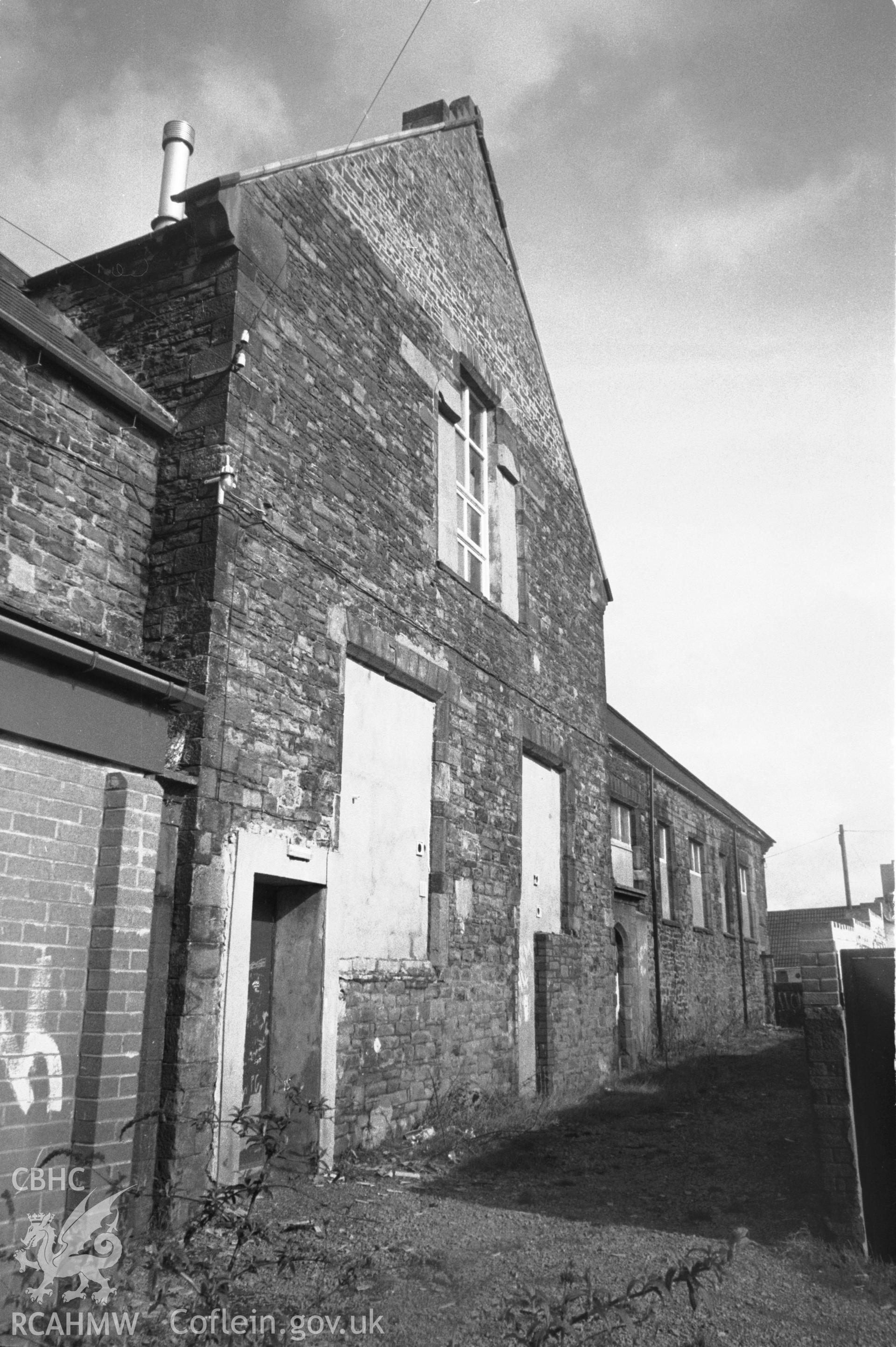 Photograph of Hafod Copperworks School, Hafod: showing the south-east playground facade and the central gable from the south-west.