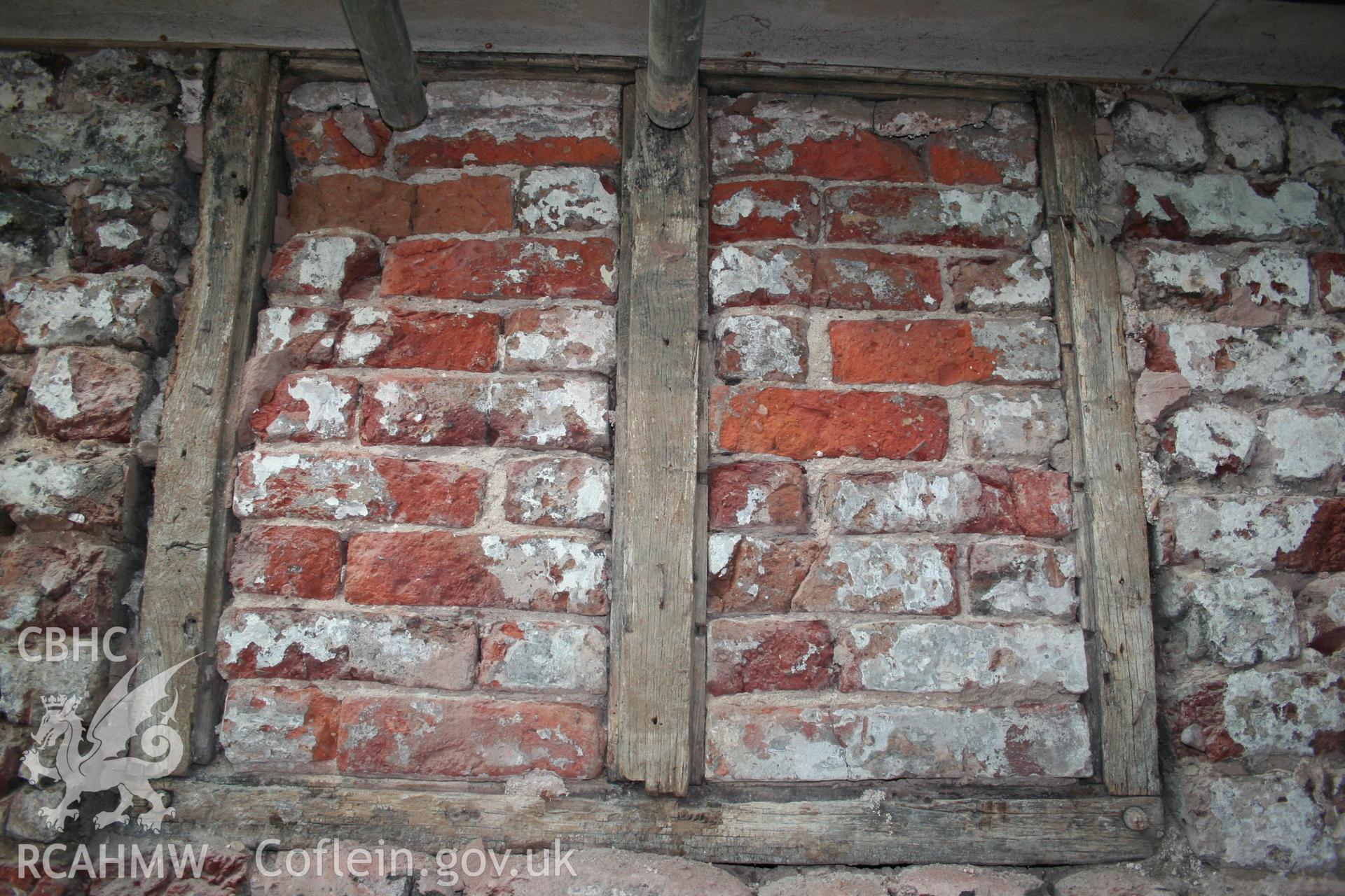 Exterior, first-floor casement window in west elevation of rear-wing, over doorway