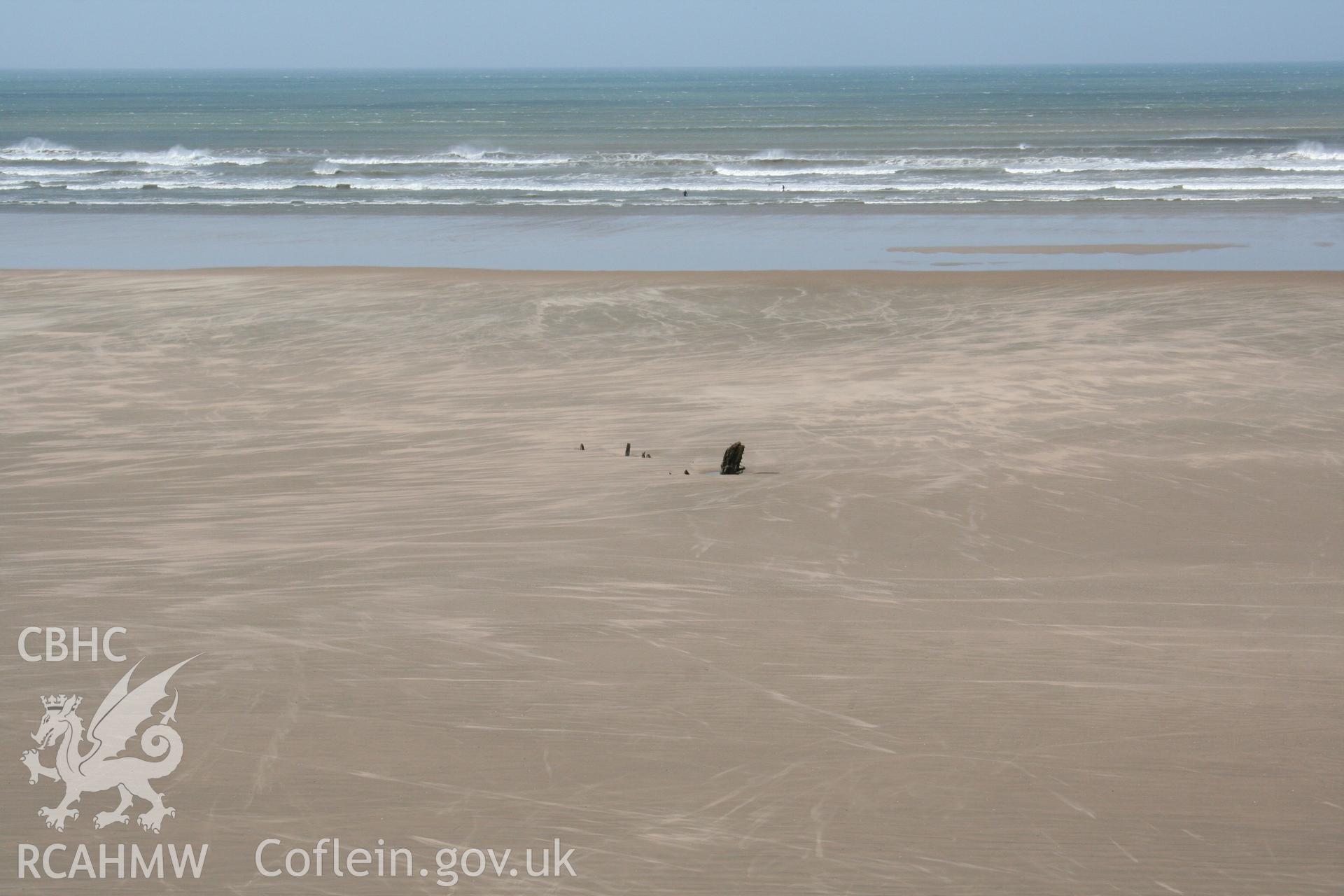 Traces of the Helvetia projecting above Rhossili Beach, viewed from the east
