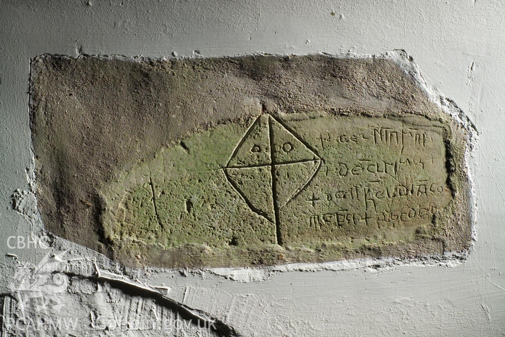 Inscribed stone set in interior north wall