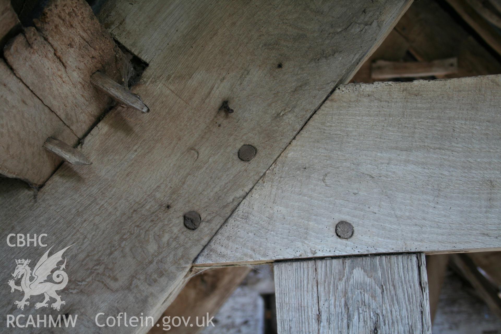 Interior of framed barn, detail of joint at collar of end-truss.