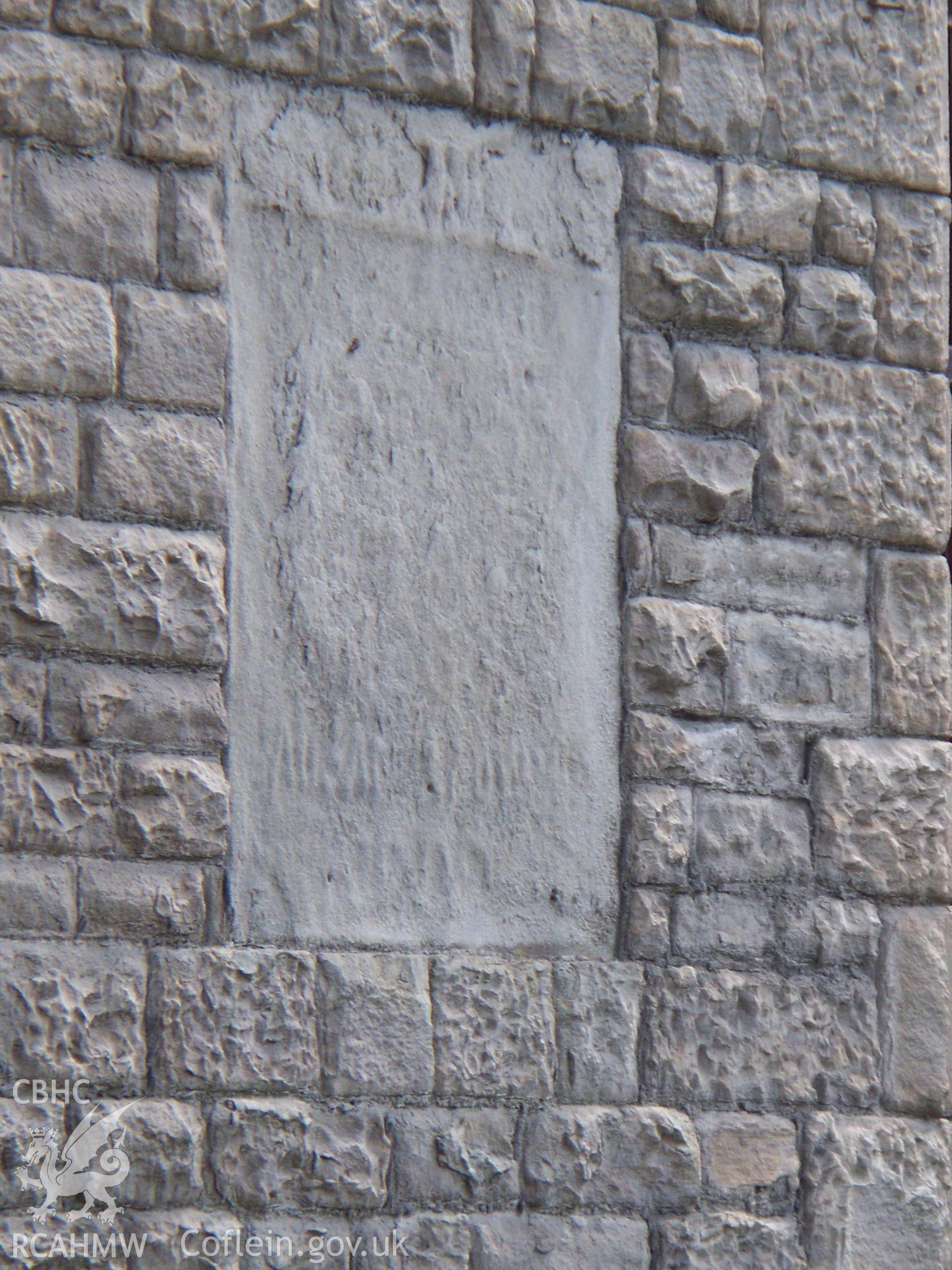 Eroded plaque on the NW entrance.