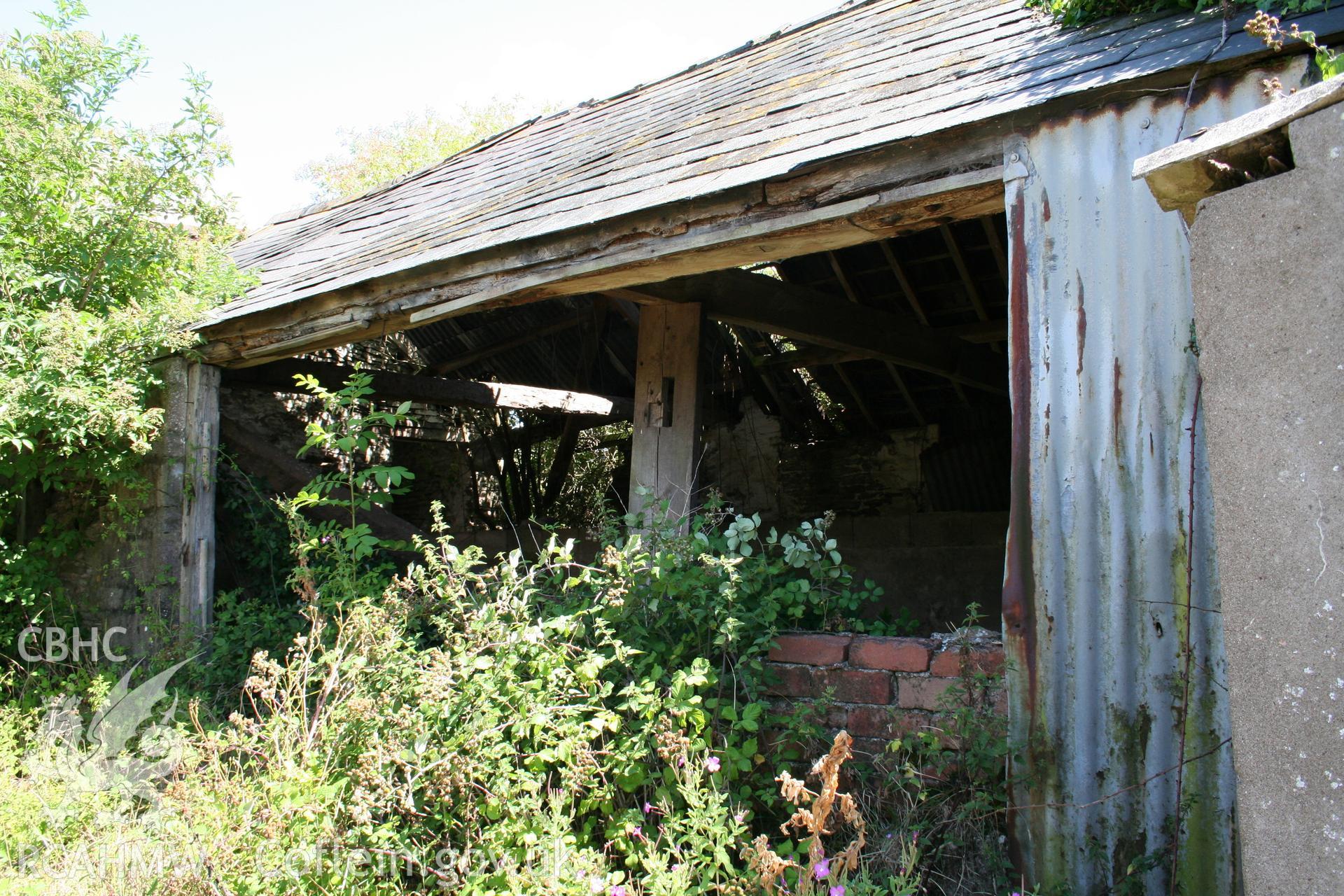 Exterior  of cow-house at right angles to barn part open-fronted.