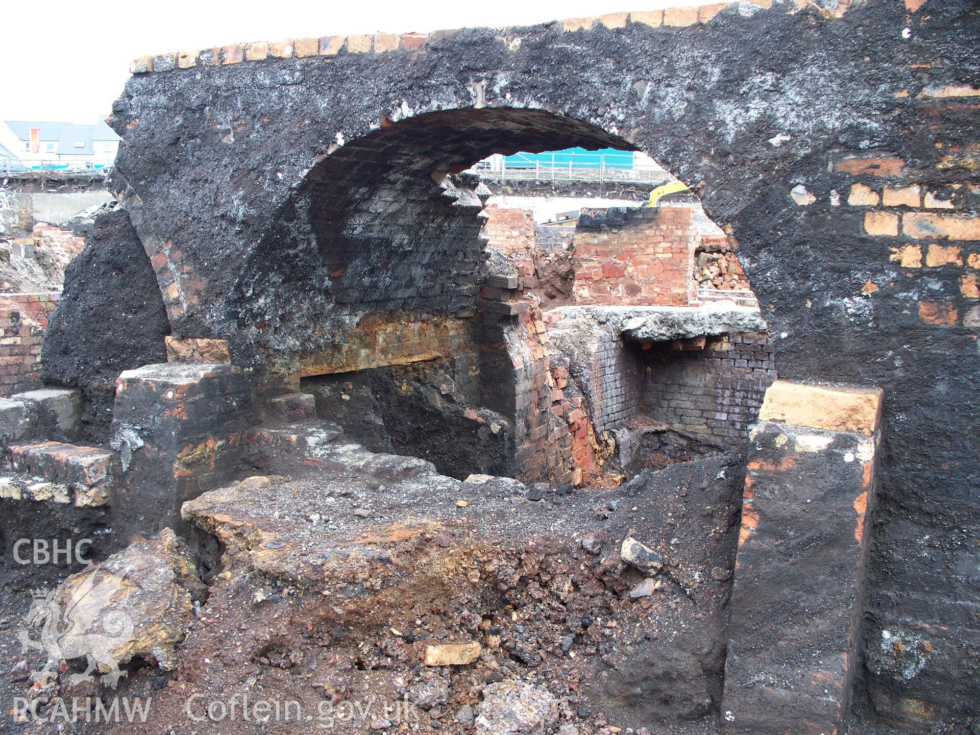 Arch of gas regenerative furnace on W riverside of former zinc works.